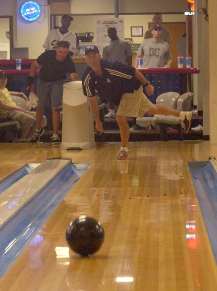Chief Master Sgt Michael David, from the 8th Communications Squadron, competes in a bowling match between the Chiefs and the Airmen Committed to Excellence (ACE) June 23 here.  (U.S. Air Force photo/ Staff Sgt. Darcie Ibidapo)