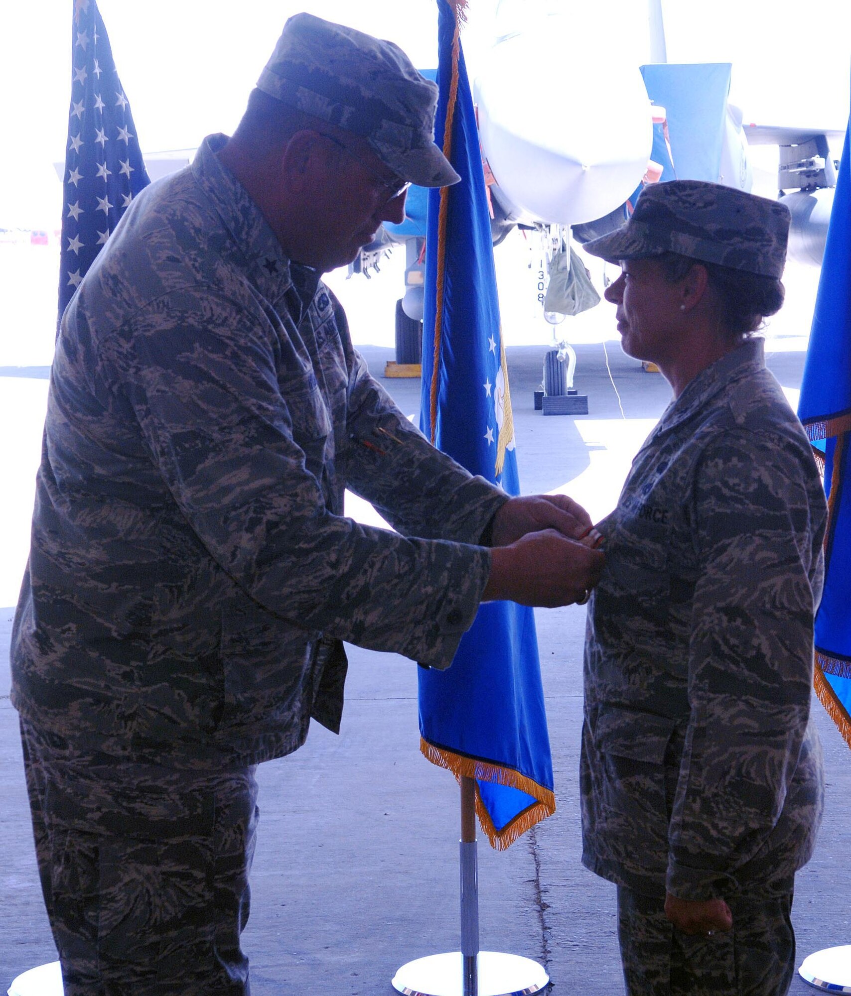 Brig. Gen. Bill Hyatt (left), 455th Air Expeditionary Wing commander, awards Col. Jennifer Walter, 755th Air Expeditionary Group commander, with the Afghanistan Campaign Medal at a change of command ceremony July 1 at Bagram Airfield, Afghanistan. (U.S. Air Force photo by Staff Sgt. Craig Seals)