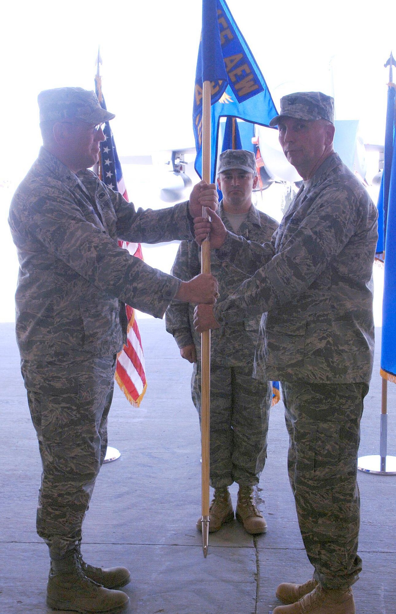 Col. Fred Fairhurst (right) accepts the 755th Air Expeditionary Group guidon from Brig. Gen. Bill Hyatt, 455th Air Expeditionary Wing commander, signifying the change of command during a ceremony July 1 at Bagram Airfield, Afghanistan. (U.S. Air Force photo by Staff Sgt. Craig Seals)