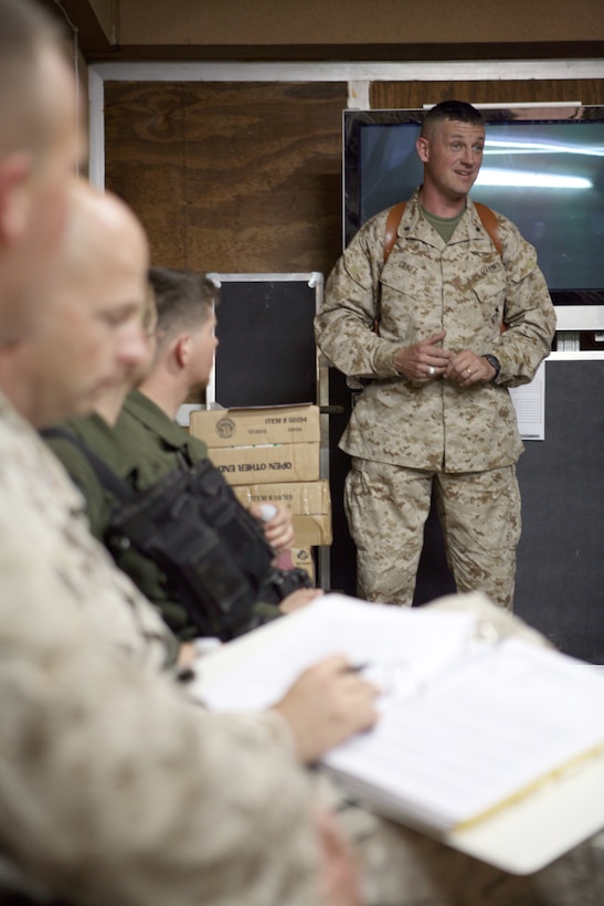 AL ASAD, Iraq - Lt. Col. Joseph Craft, the commanding officer of Marine All-Weather Fighter Attack Squadron 121, speaks to the Marines taking part in the squadron's Incident Free Liberty Campaign during the initial meeting, July 3. The two task forces in the campaign, Victor and Kilo, devised separate courses of action to keep Marines alive after they come home from deployment.