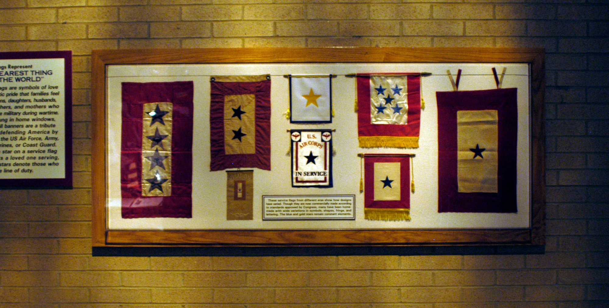 DAYTON, Ohio - These service flags from different eras show how designs have varied. Though they are now commercially made according to standards approved by Congress, many have been home-made with wide variations in symbols, shapes, fringe and lettering. The blue and gold stars remain constant elements. The flags are on display in Kettering Hall at the National Museum of the U.S. Air Force. (U.S. Air Force photo)