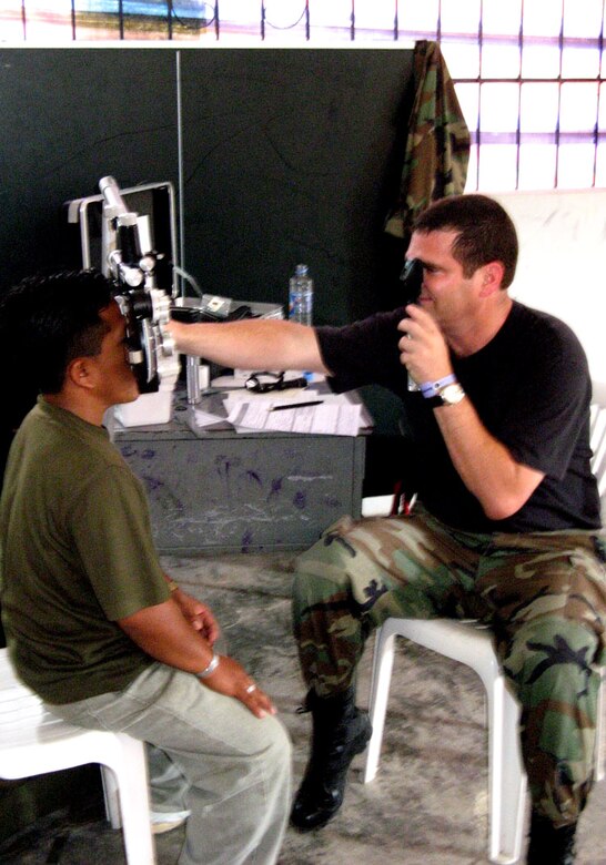 Maj. Don Hamer checks a local Ecuadorian's eyes while deployed to the South American country. Fourteen Airmen traveled there from Holloman Air Force Base, N.M., for two weeks on a humanitarian assistance deployment and treated more than 6,800 patients and filled more than 17,500 prescriptions. Major Hamer is a 49th Medical Group optometrist. (U.S. Air Force photo) 
