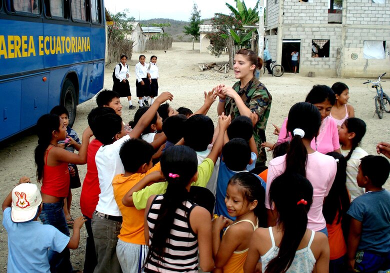 Airman 1st Class Ashley Couturier hands candy out to local children while deployed to Ecuador. Fourteen Airmen traveled there from Holloman Air Force Base, N.M., for two weeks on a humanitarian assistance deployment and treated more than 6,800 patients and filled more than 17,500 prescriptions. Airman Couturier is assigned to the 49th Aeromedical Dental Squadron. (U.S. Air Force photo)
