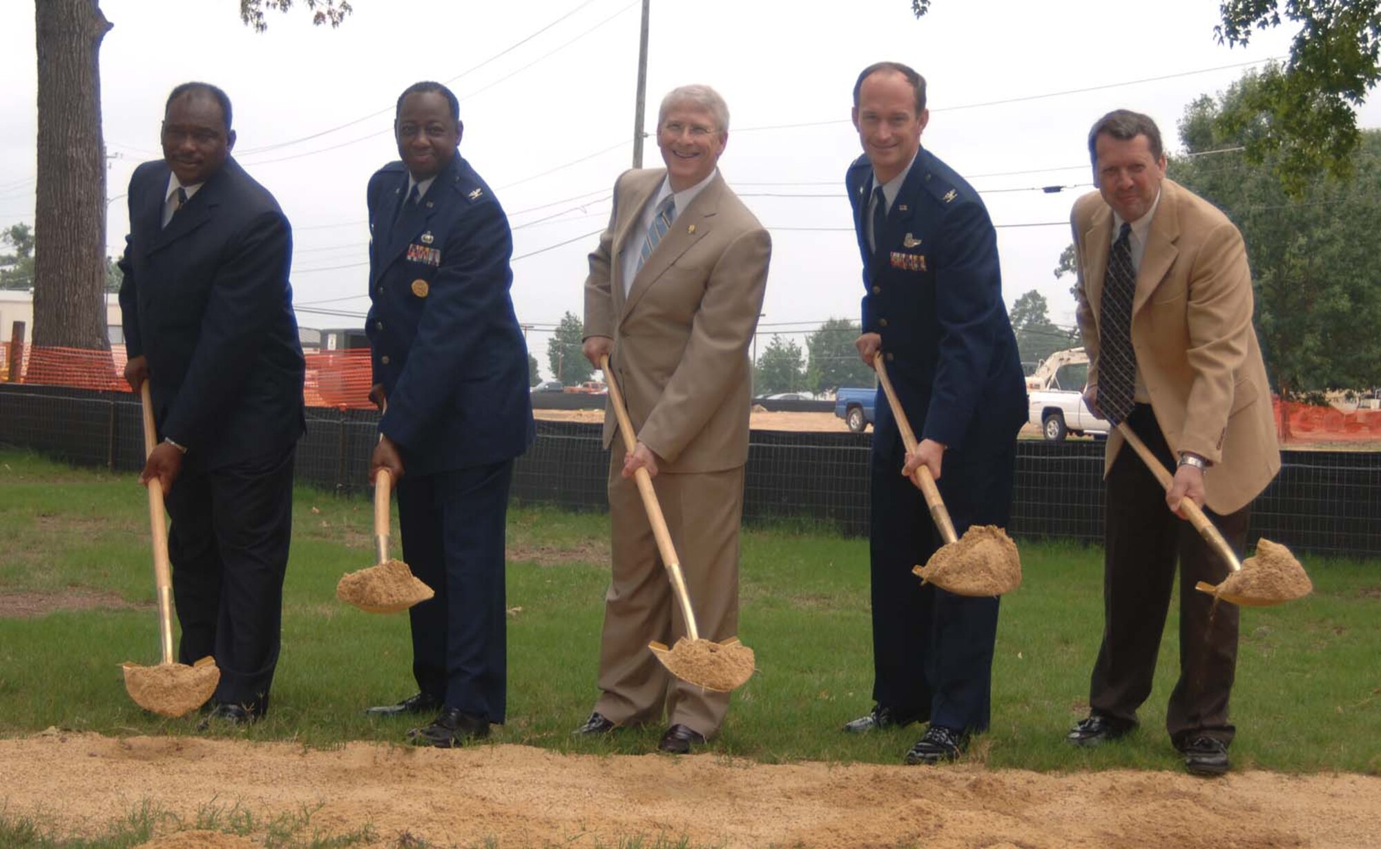 Colonel Dave Gerber, 14th Flying Training Wing commander, shovels dirt at the 14th Mission Support Group Complex. He is accompanied by, from left to right, the Honorable Robert Smith, Mayor of the City of Columbus, Col. Mark Brown, 14th Mission Support Group commander, Mississippi Congressman Roger Wicker and Steve Arendale, U.S. Army Corp of Engineers. Each scooped a load of dirt with their golden shovels to commemorate the event. (U.S. Air Force Photo by Airman 1st Class Danielle Powell)