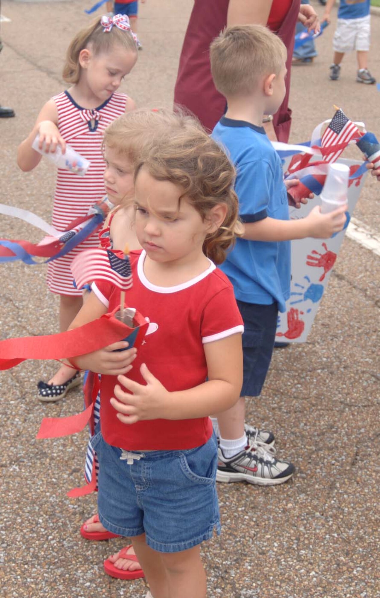 Youth at the Child Development Center take part in a parade Tuesday to celebrate Independence Day. Youth made noise makers and carried flags through the parade. Many parents were onsite to watch the children march. (U.S. Air Force Photo by Airman 1st Class Danielle Powell)