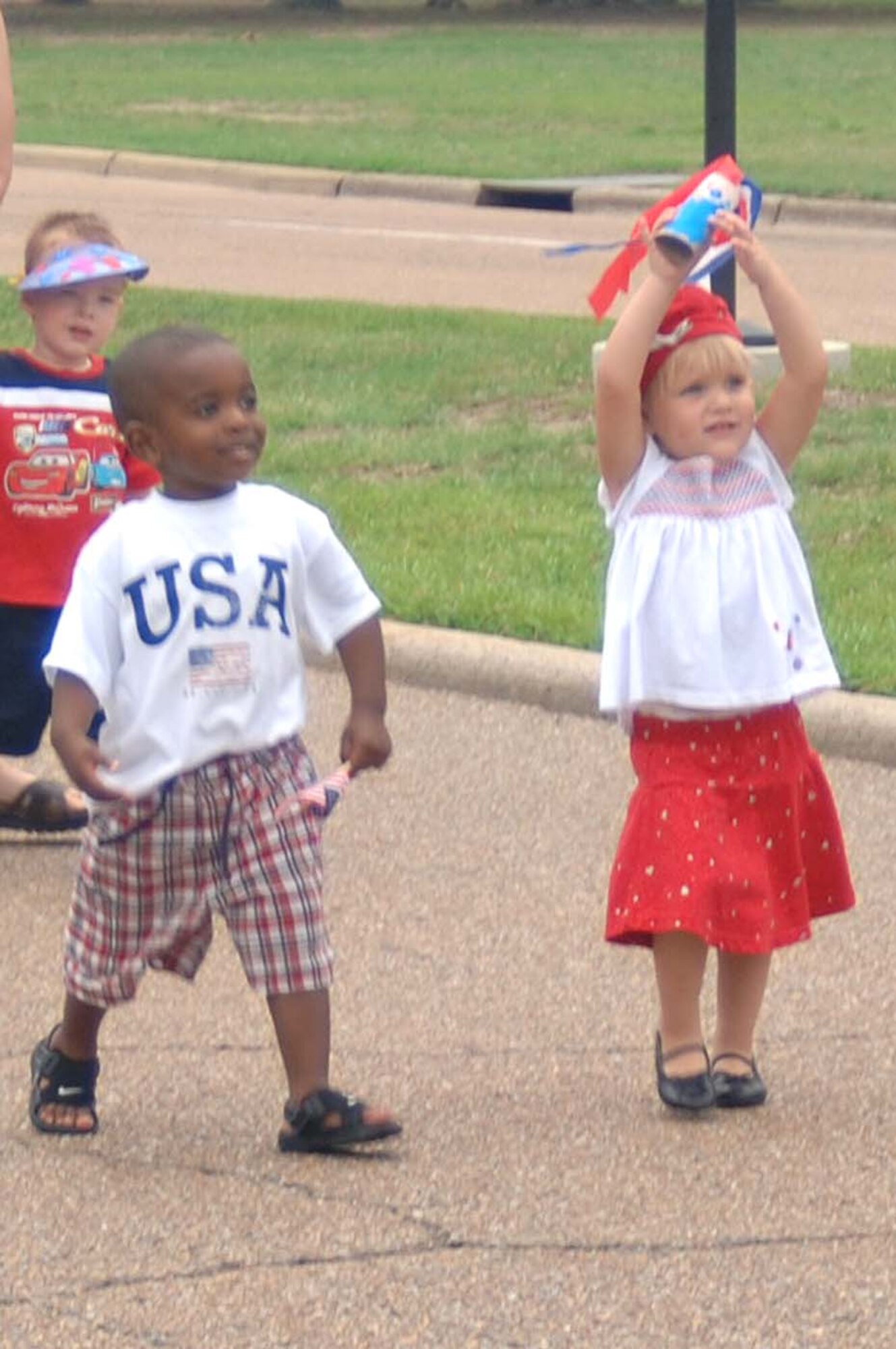Youth at the Child Development Center take part in a parade Tuesday to celebrate Independence Day. Youth made noise makers and carried flags through the parade. Many parents were onsite to watch the children march. (U.S. Air Force Photo by Airman 1st Class Danielle Powell)