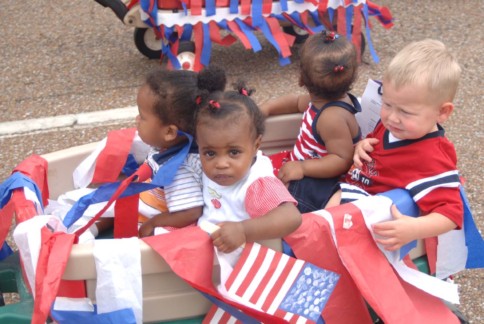 Youth at the Child Development Center take part in a parade Tuesday to celebrate Independence Day. Youth made noise makers and carried flags through the parade. Many parents were onsite to watch the children march. (U.S. Air Force Photo by Airman 1st Class Danielle Powell)