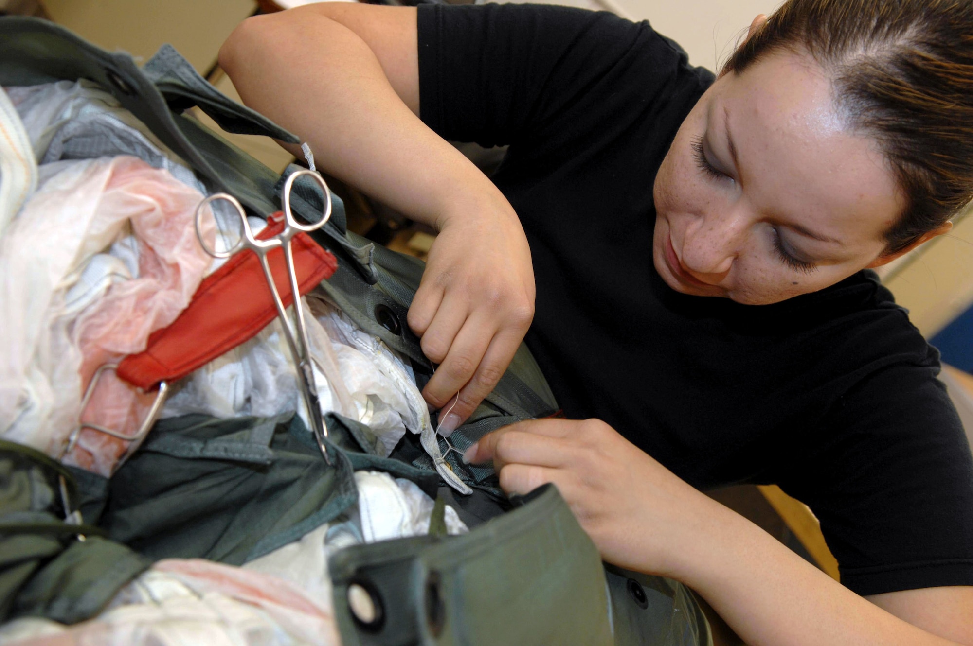 Senior Airman Brenda Schaub packs a parachute June 25 at Davis-Monthan Air Force Base, Ariz.  Airman Schaub is an aircrew flight equipment journeyman assigned to the 355th Operation Support Squadron where she also maintains, repairs, and fabricates other types of survival equipment. (U.S. Air Force photo/Senior Airman Christina D. Ponte)