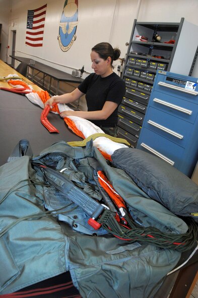 Senior Airman Brenda Schaub packs a parachute June 25 at Davis-Monthan Air Force Base, Ariz.  Airman Schaub is an aircrew flight equipment journeyman assigned to the 355th Operation Support Squadron where she also maintains, repairs, and fabricates other types of survival equipment. (U.S. Air Force photo/Senior Airman Christina D. Ponte)