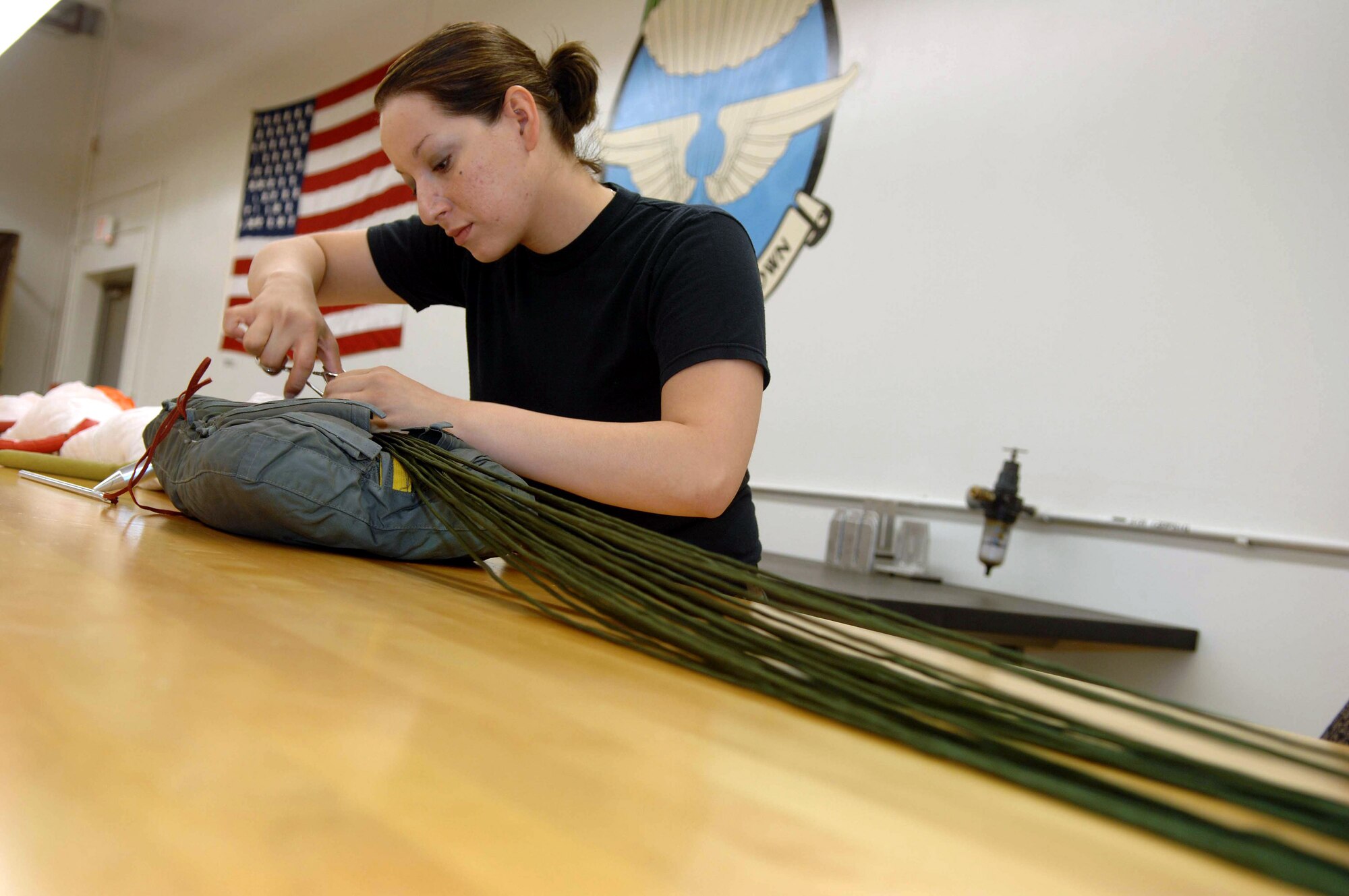 Senior Airman Brenda Schaub packs a parachute June 25 at Davis-Monthan Air Force Base, Ariz.  Airman Schaub is an aircrew flight equipment journeyman assigned to the 355th Operation Support Squadron where she also maintains, repairs, and fabricates other types of survival equipment. (U.S. Air Force photo/Senior Airman Christina D. Ponte)