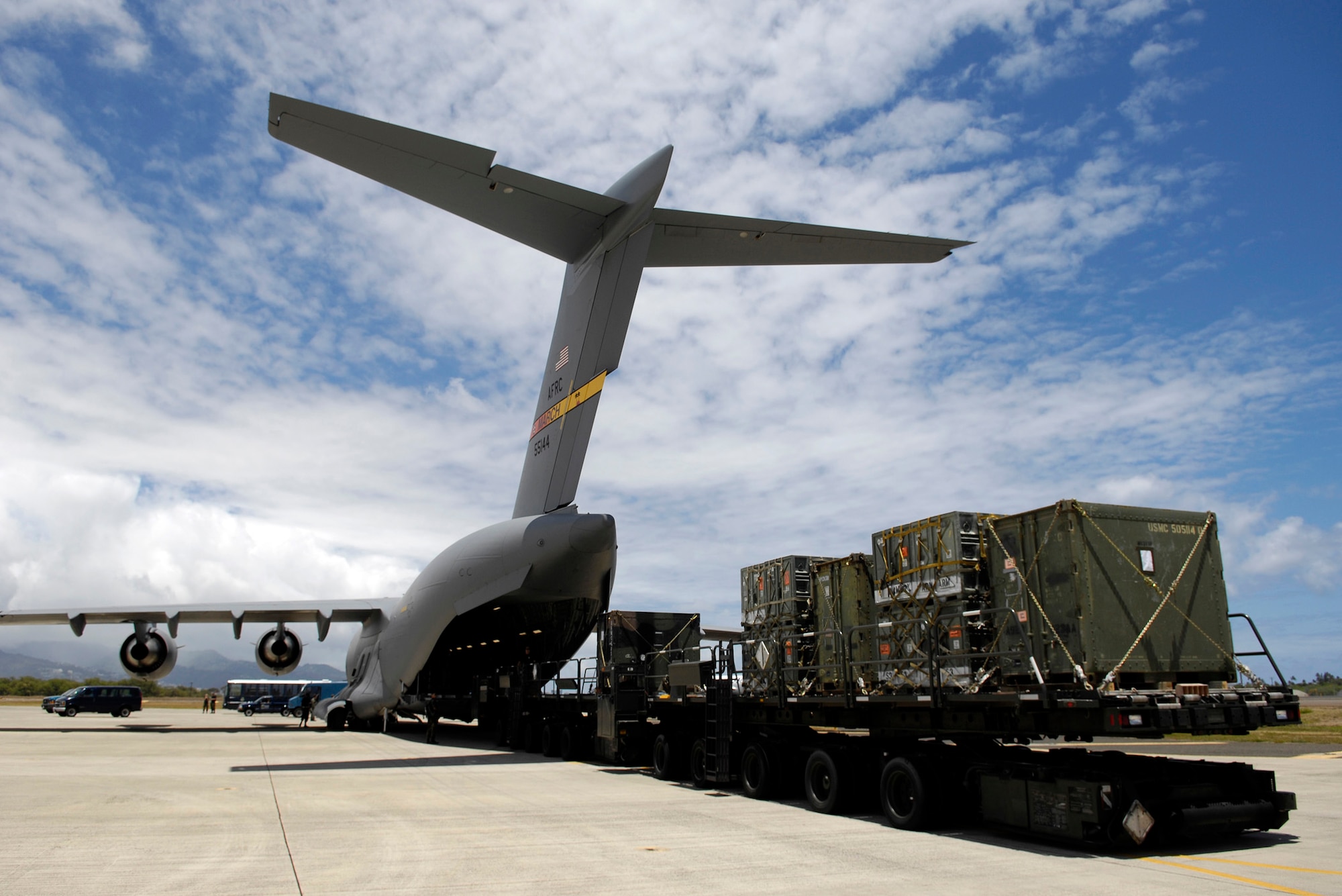 A C-17 Globemaster III is unloaded July 2 at Hickam Air Force Base, Hawaii. Reservists from the 87th Aerial Port Squadron from Wright-Patterson AFB, Ohio, are conducting their two-week duty with the 735th Air Mobility Squadron. (U.S. Air Force photo/Tech. Sgt. Shane A. Cuomo)