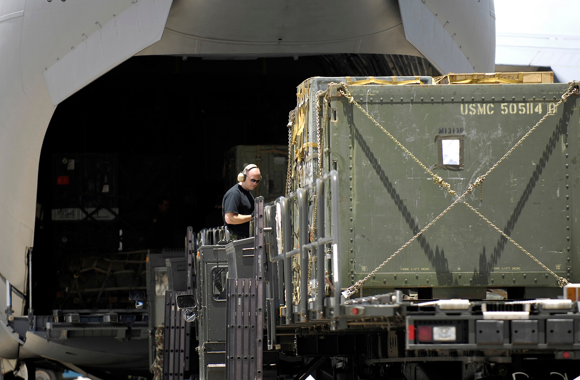 An air transportation specialist helps unload a C-17 Globemaster III July 2 at Hickam Air Force Base, Hawaii. Reservists from the 87th Aerial Port Squadron from Wright-Patterson AFB, Ohio, are conducting their two-week duty with the 735th Air Mobility Squadron. (U.S. Air Force photo/Tech. Sgt. Shane A. Cuomo)
