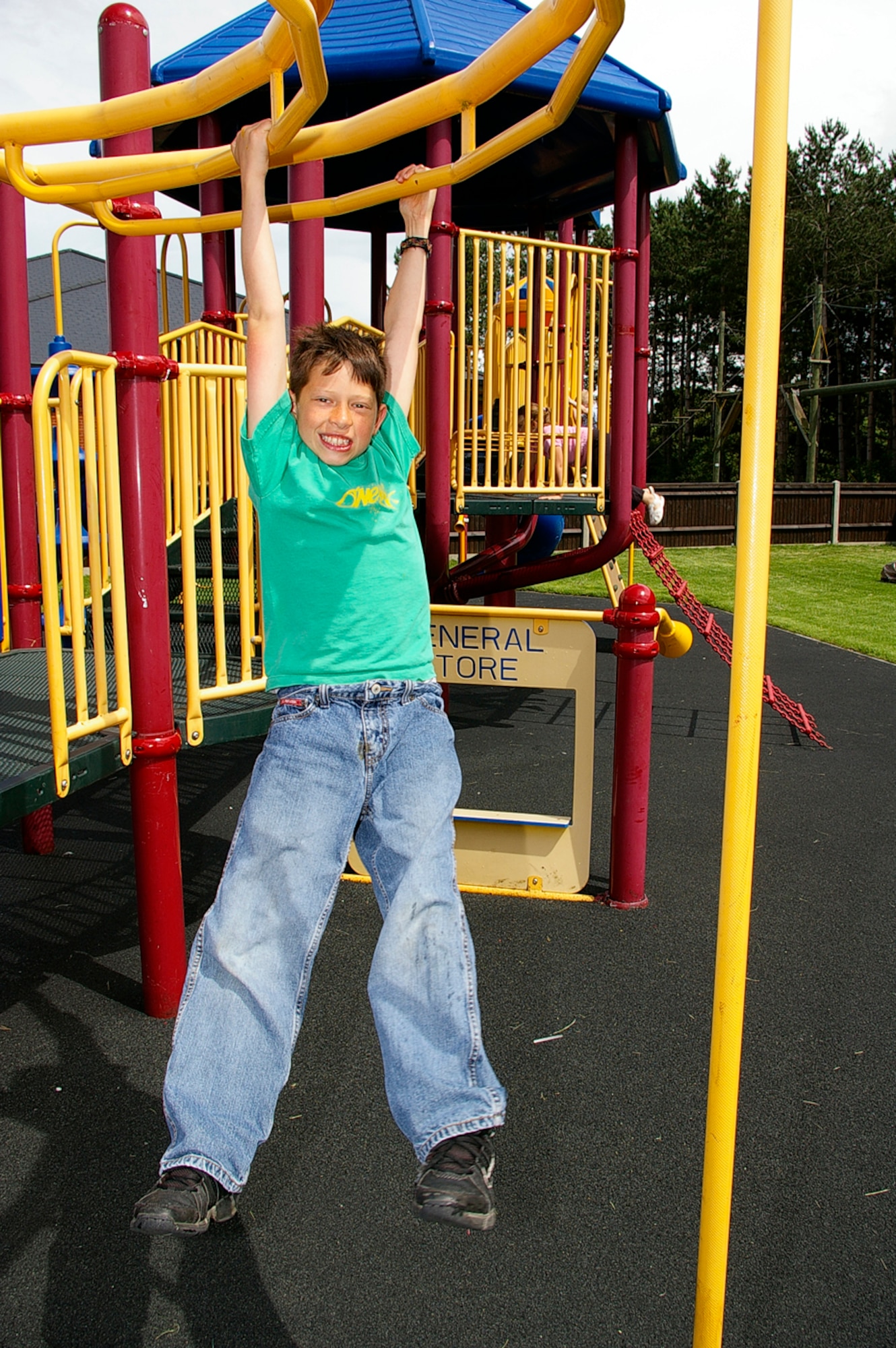 Colton Thomas, 10, an RAF Mildenhall family member, swings on the bars at play area in Heritage Park July 3. Heritage Park officially opened July 3 and is available for rent through outdoor recreation. The park is open 24 hours a day, seven days a week. (U.S. Air Force photo by Karen Abeyasekere)