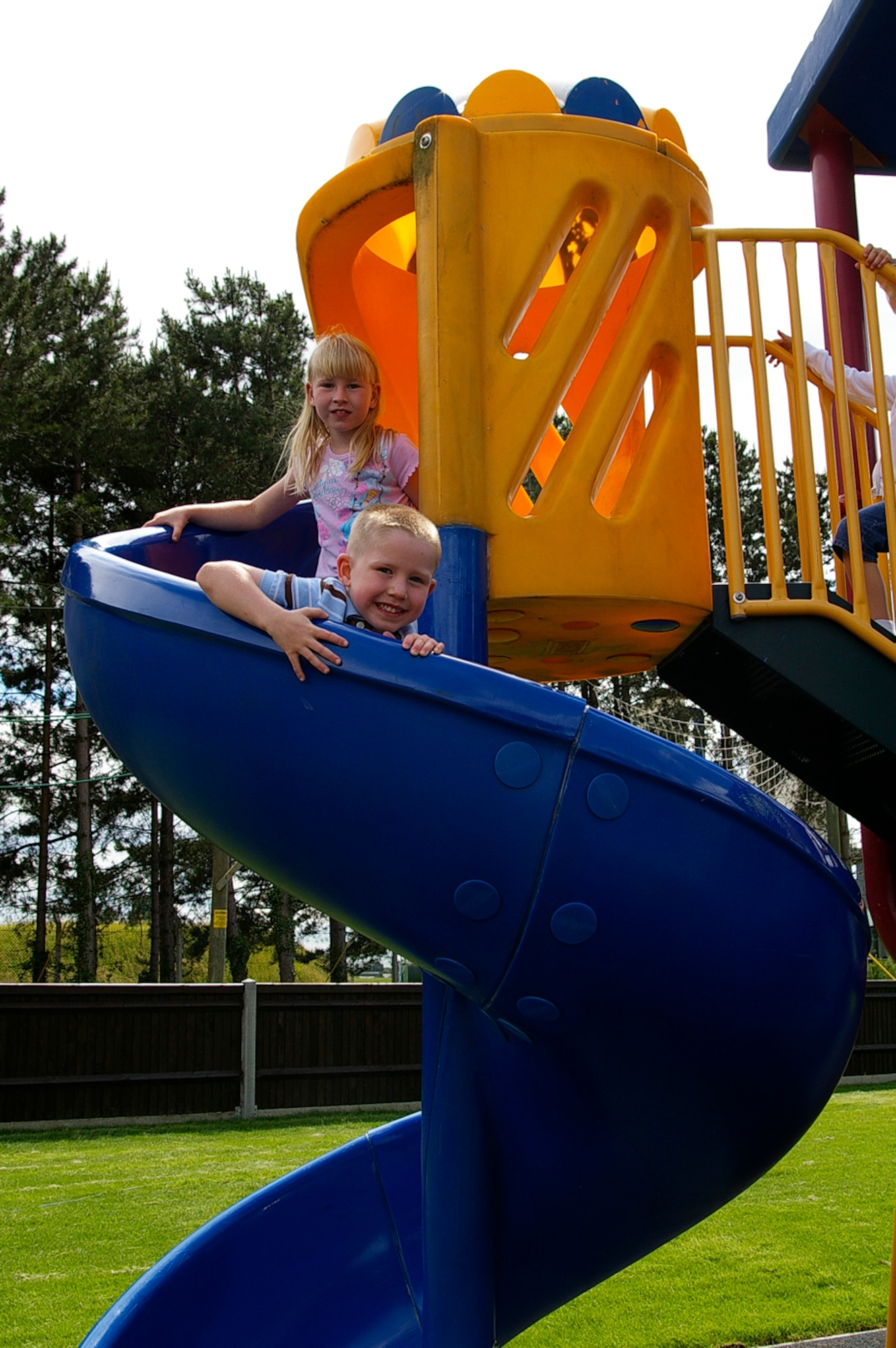 Hayley Taylor, 7, and her brother, Dillon, 5, play on the slide in the newly-opened Heritage Park near the post office and outdoor recreation. Heritage Park officially opened July 3 and has a children's play area, gazebo and barbecue area (brick barbecues are yet to be built). The area is available for rent, both privately and by squadrons. (U.S. Air Force photo by Karen Abeyasekere)