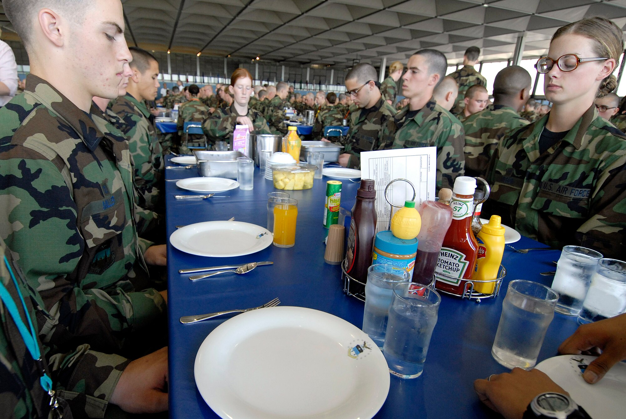 Basic cadet trainees must not take their eyes off the eagle on their plate as they prepare for their first lunch meal since arriving as the Class of 2011 June 29 at the U.S. Air Force Academy in Colorado. They are in the first half of basic cadet training, commonly known as "First Beast." (U.S. Air Force photo/Mike Kaplan) 
