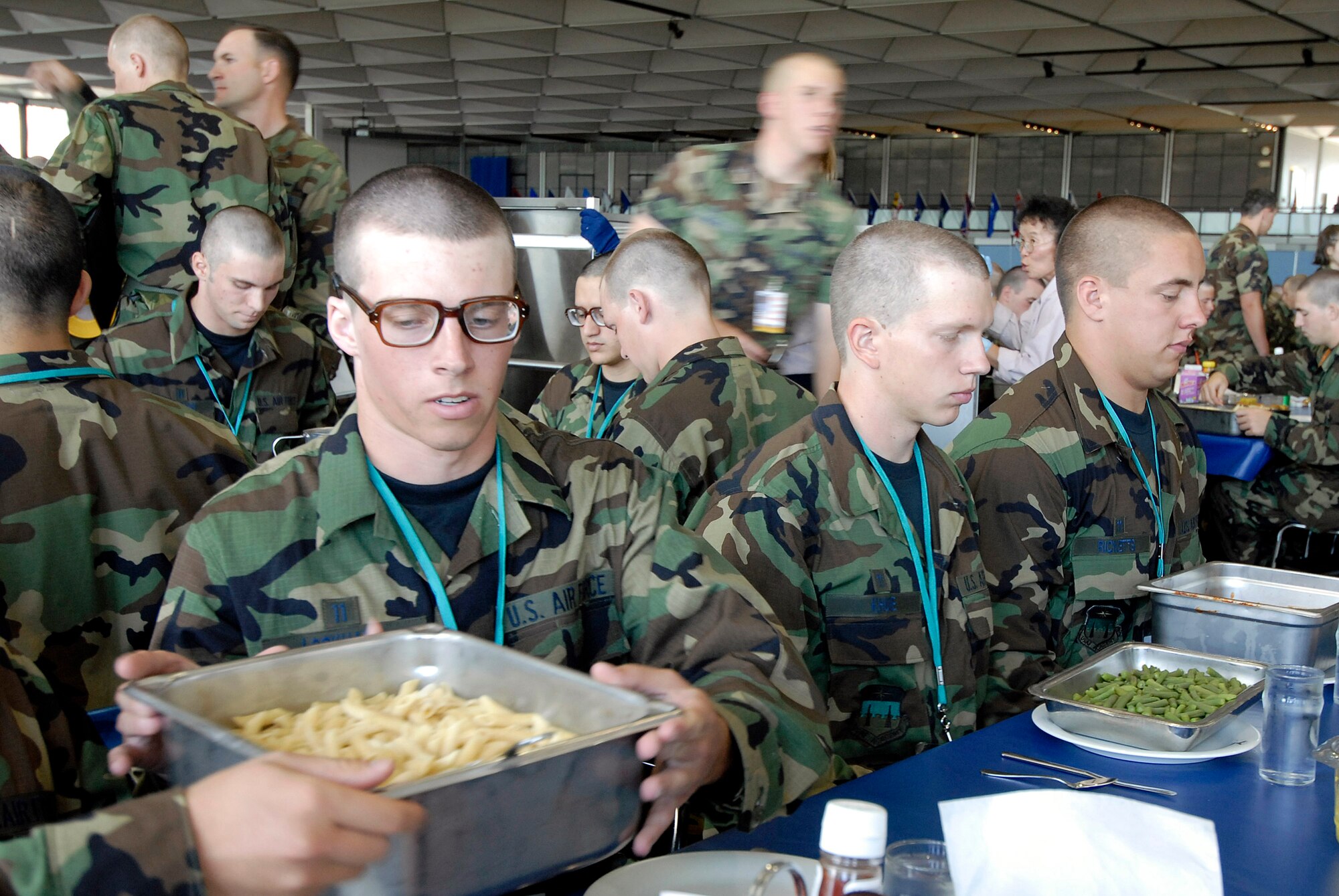 Basic cadet trainees prepare for their first lunch since arriving as the Class of 2011 June 29 at the U.S. Air Force Academy in Colorado. The cadets are in their first week of training and must not take their eyes off the eagle on their plate as they eat. They are in the first half of basic cadet training, commonly known as "First Beast." (U.S. Air Force photo/Mike Kaplan) 
