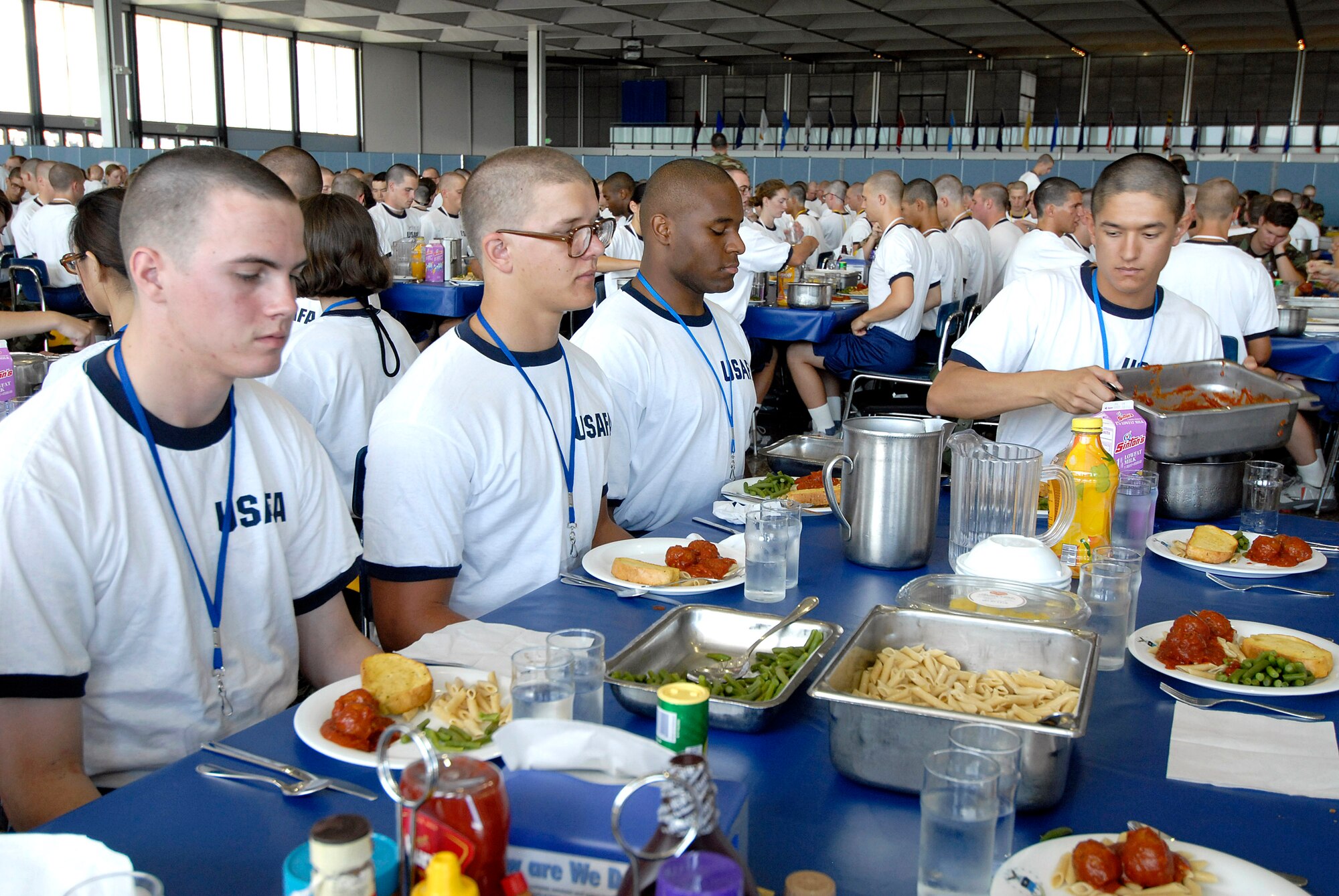 Basic cadet trainees prepare for their first lunch since arriving as the Class of 2011 June 29 at the U.S. Air Force Academy in Colorado. The cadets are in their first week of training and must not take their eyes off the eagle on their plate as they eat. They are in the first half of basic cadet training, commonly known as "First Beast." (U.S. Air Force photo/Mike Kaplan) 
