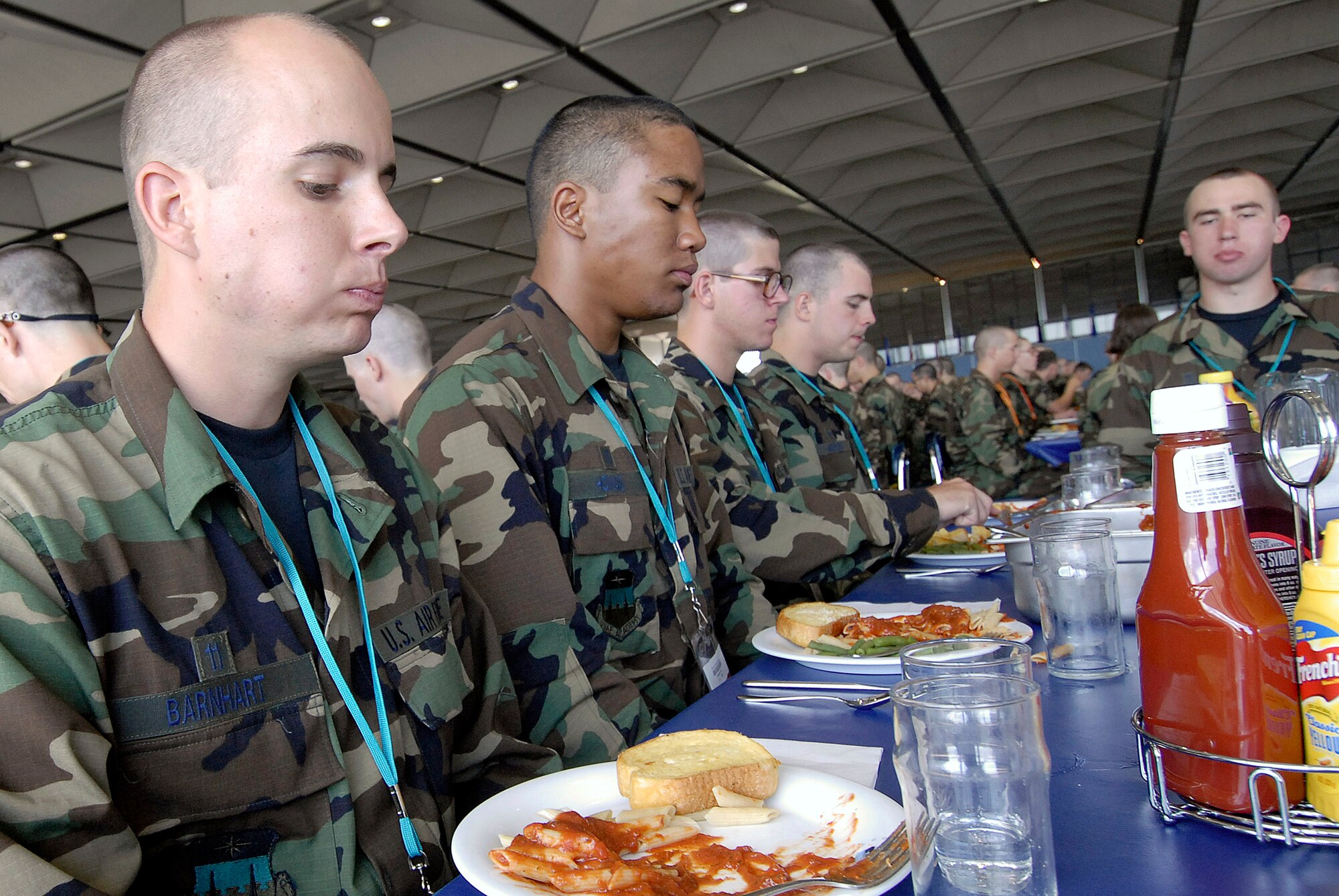 Basic cadet trainees prepare to eat their first lunch since arriving as the Class of 2011 June 29 at the U.S. Air Force Academy in Colorado. The cadets are in their first week  of training and must not take their eyes off the eagle on their plate as they eat. They are in the first half of basic cadet training, commonly known as "First Beast." (U.S. Air Force photo/Mike Kaplan) 
