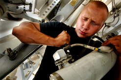 Airman 1st Class Josh Ramalia, 437th Aircraft Maintenance Squadron hydraulics systems apprentice from blue knights aircraft maintenance unit, works on the main landing gear retracting actuator for a Charleston C-17 on the flightline June 29.   (U.S. Air Force Photo/Airman 1st Class Nicholas Pilch)