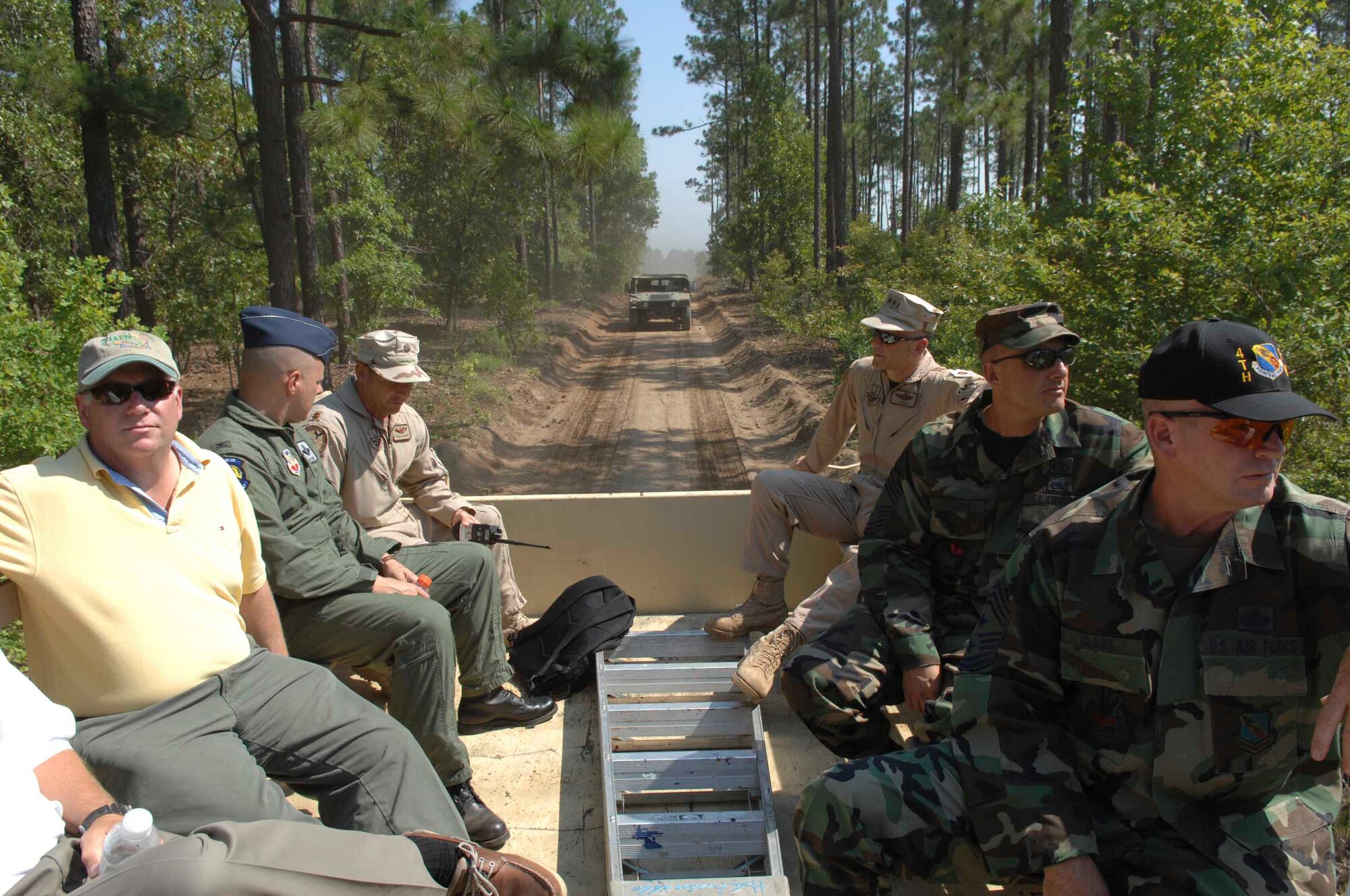 POINSETT RANGE, S.C. -- Nineth Air Force Civic Leaders ride in the bay of a five-ton truck during a convoy tour of Poinsett Range June 22. The convoy was part of a civic leader conference hosted by Lt. Gen. Gary North, 9th Air Force and U.S. Central Command Air Forces commander, June 21-23. Civilians representing communities from 9th Air Forces bases and direct reporting units attended, The conference was an opportunity to show civic leaders throughout 9th AF some of the day-to-day experiences Airmen face while at home and deployed.  (U.S. Air Force photo by Staff Sergeant Josef Cole)