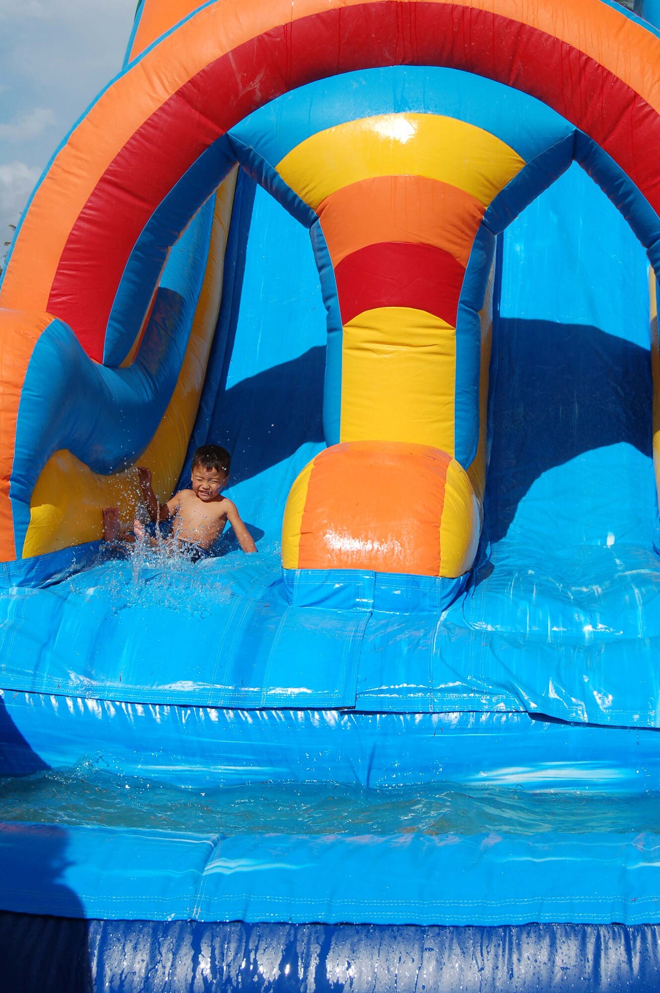 Jordan Sampson, son of Staff Sgt. Reginald Simpson from the 36th Munitions Squadron, enjoys the water slide during Freedom Fest Tuesday at Arc Light Park. (U.S. Air Force Photo/Airman 1st Class Carissa Morgan)