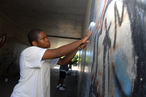 Staff Sgt. Antonio Montgomery, 18th Component Maintenance Squadron, paints a graffiti wall at a park outside of Kadena's Gate 2 as part of a humanitarian and beatification project  June 30.  More than 18 people volunteered to paint the tunnel which was covered in graffiti. 
U.S. Air Force Photo/Senior Airman Jeremy McGuffin