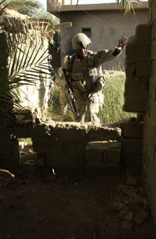 070629-F-6304H-113 
      U.S. Army Sgt. Antwon Monroe makes his way through rough terrain to reach his next objective near Baqubah, Iraq, on June 29, 2007.  Monroe is assigned to Charlie Company, 1st Battalion, 12th Cavalry Regiment.  