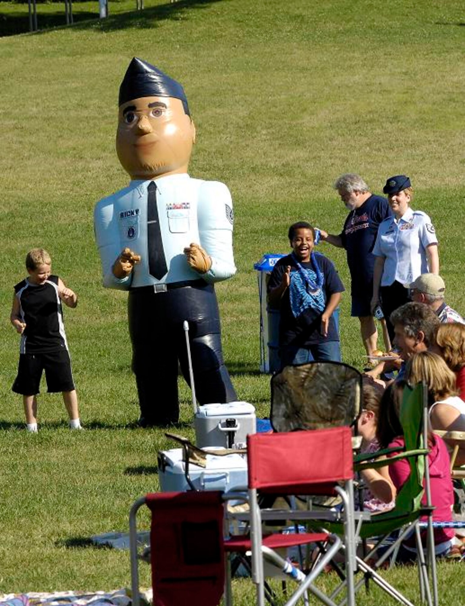Tech Sgt. Tracy Bennett and spectators look on as Ricky the Recruiter dances with a few children at the Jefferson Barrack Blast, July 3, 2007.  St. Louis County, in partnership with the Air Force during Air Force Week, put on the blast, entertaining the more than 20,000 in attendance. 
(U.S. Air Force photo/Staff Sgt. Brian Ferguson)