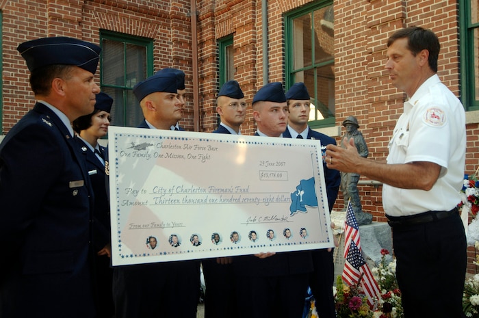 Fire Chief Rusty Thomas, chief of the Charleston Fire Department, expresses his appreciation to the 437th Operations Support Squadron members for all the time they voluntarily gave to raise more than $13,000 for the City of Charleston Firefighter's Fund June 29.  (U.S. Air Force photo/ Staff Sgt. April Quintanilla)
