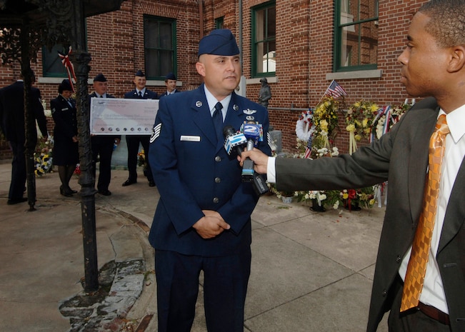 Tech. Sgt. Sidney Deleon-Mazariejos, 437 OSS NCO in charge of training of the Special Weapons Tactics Flight, gives his comments to local news stations on how and why he initiated the fundraiser on base. (U.S. Air Force photo/ Staff Sgt. April Quintanilla)