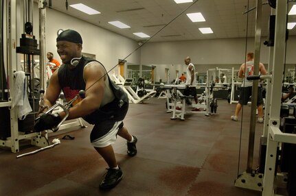 Tyrone Herron, 437th Aircraft Maintenance Squadron, works his chest and shoulder muscles using the standing cable crossover at Charleston's Fitness and Sports Center Tuesday.   (U.S. Air Force Photo/Airman 1st Class Nicholas Pilch)