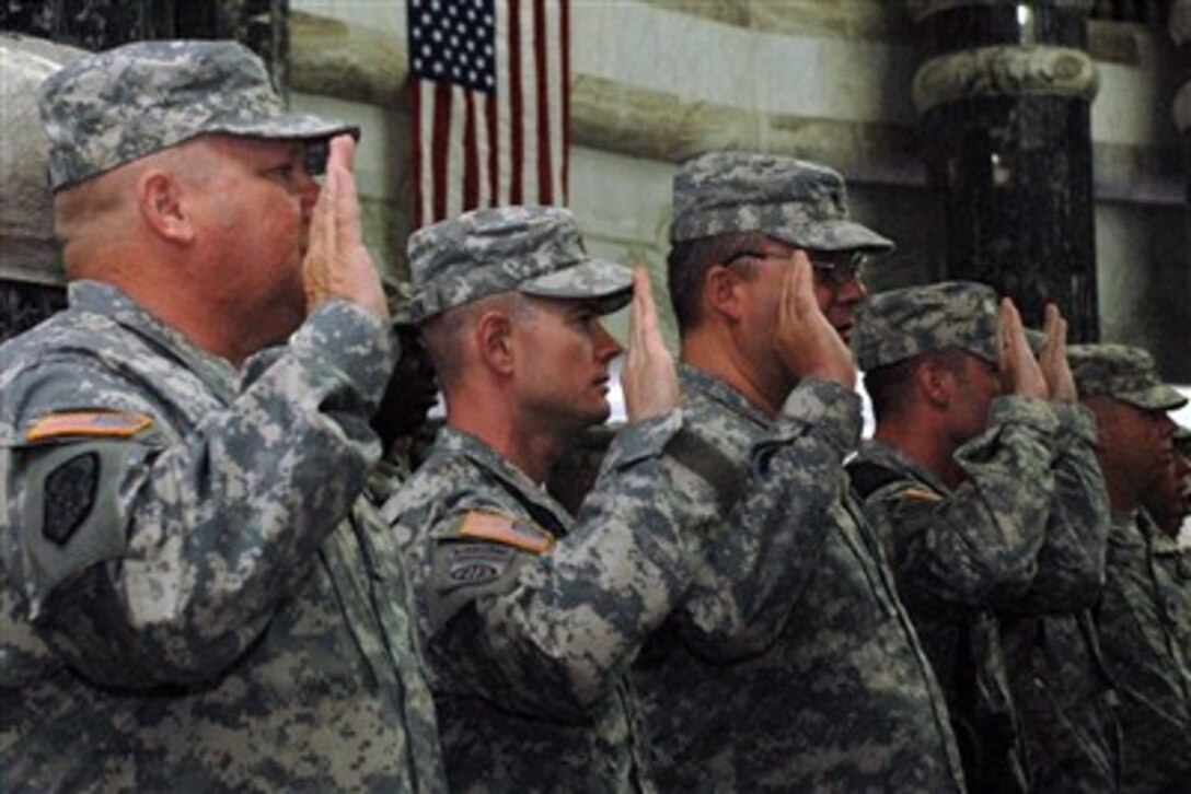 Led by Army Gen. David Petraeus, soldiers swear the Oath of Enlistment during the Multi-National Force-Iraq Re-enlistment, Naturalization and Independence Day Ceremony July 4 at Camp Victory, Iraq.