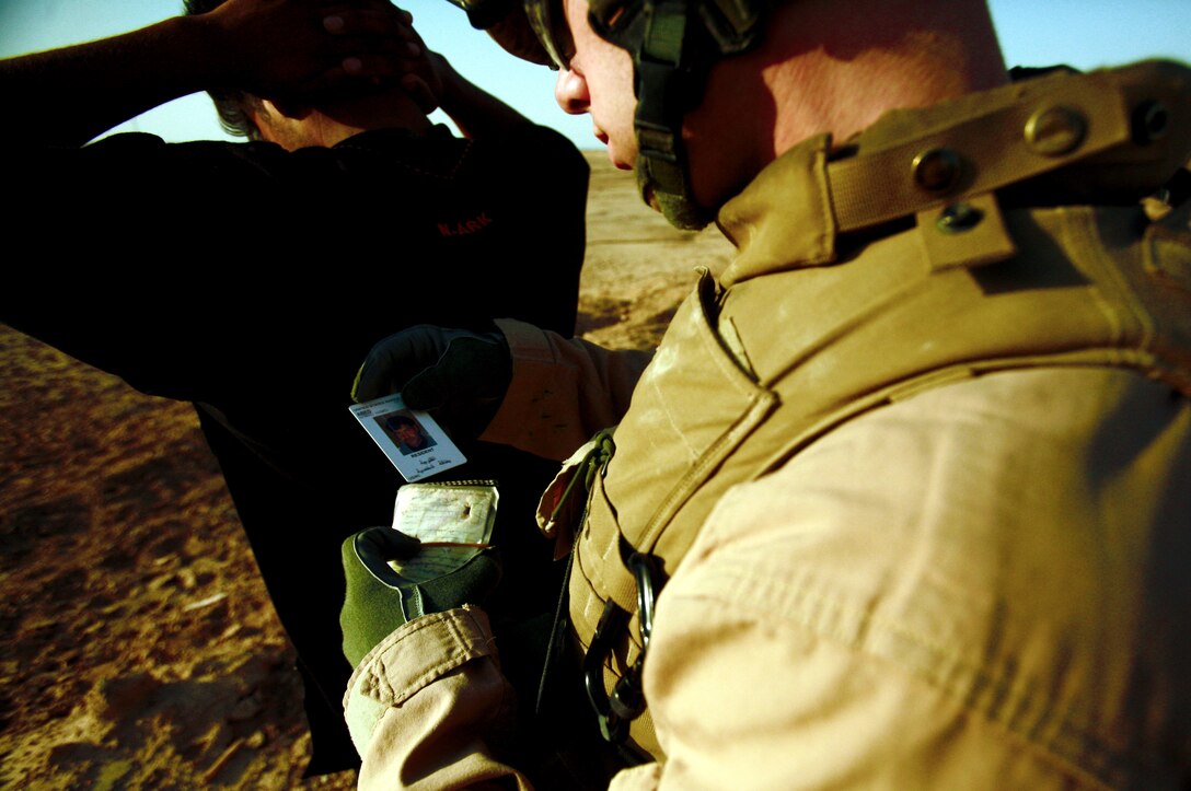 AL TAQADDUM, Iraq (July 7, 2007) ?  A Marine searches a local national during a security patrol here. As the insurgents try to thwart Iraq?s progress, it is the responsibility of the Marines with Military Police Company, 2nd Maintenance Battalion, 2nd Marine Logistics Group (Forward) to keep a watchful eye on the roads. At the ?tip of the spear? of the patrols are the patrol leaders mostly of whom are corporals: the junior noncommissioned officer rank in the Corps.