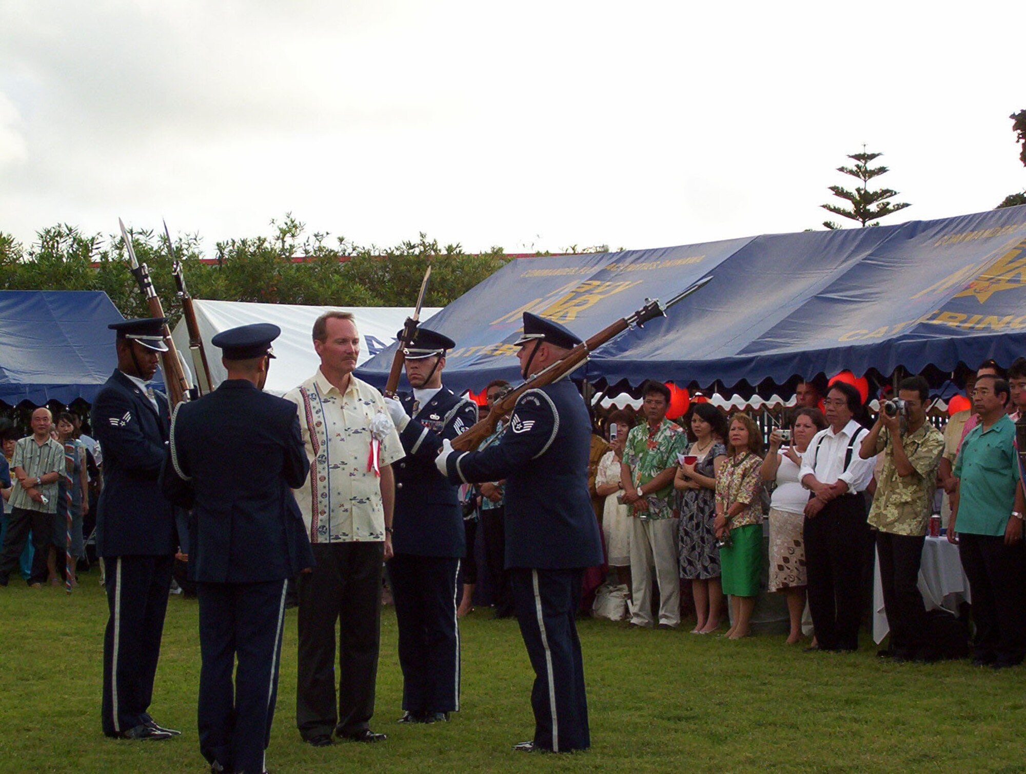 Kadena Air Base Honor Guard Drill Team performs while Consul General Kevin Maher stands in the center at the 231st United States Independence Day Ceremony and Garden Party at the U.S. Consulate in Naha, Okinawa, Japan, July 4, 2007.  The day was celebrated by more than 200 Okinawans and Americans.  In addition to the drill team, the Marine Corps III MEF Band performance, an Hawaiian Ukulele and Hula dance and a Karate performance was also enjoyed by those in attendance.  (U.S. Air Force photo by Maj. Dani Johnson)