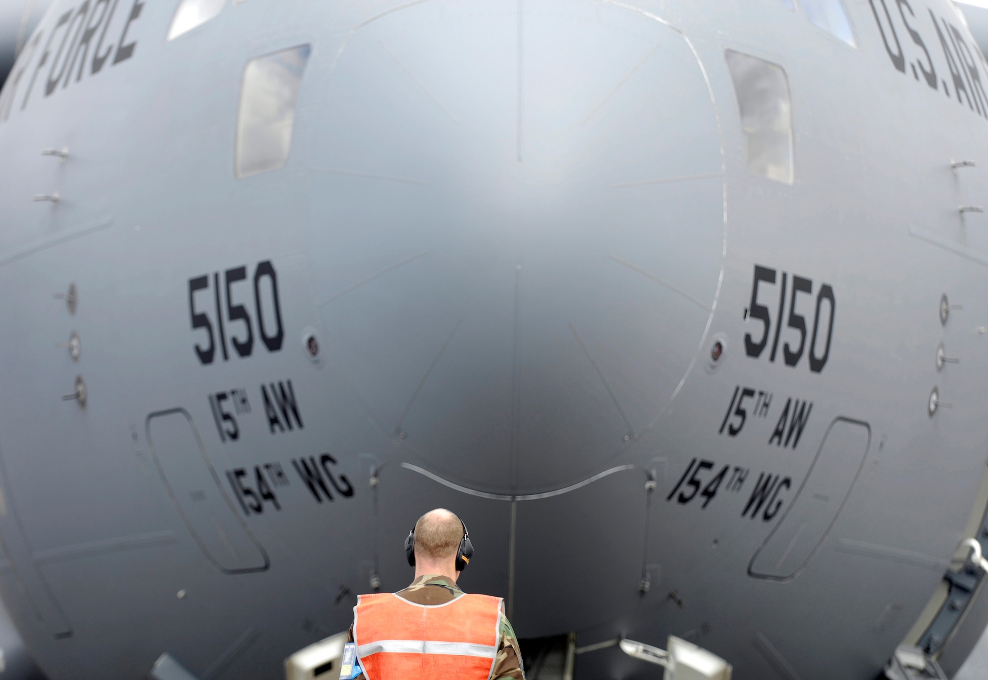 Tech. Sgt. Brad Sufka waits to launch a C-17 Globemaster III from Hickam Air Force Base, Hawaii, on June 28. Sergeant Sufka is a crew chief from the 15th Aircraft Maintenance Squadron and is part of Hickam's Rodeo team. The team is practicing for the upcoming Air Mobility Command Rodeo at McChord AFB, Wash. (U.S. Air Force photo/Tech. Sgt. Shane A. Cuomo)
