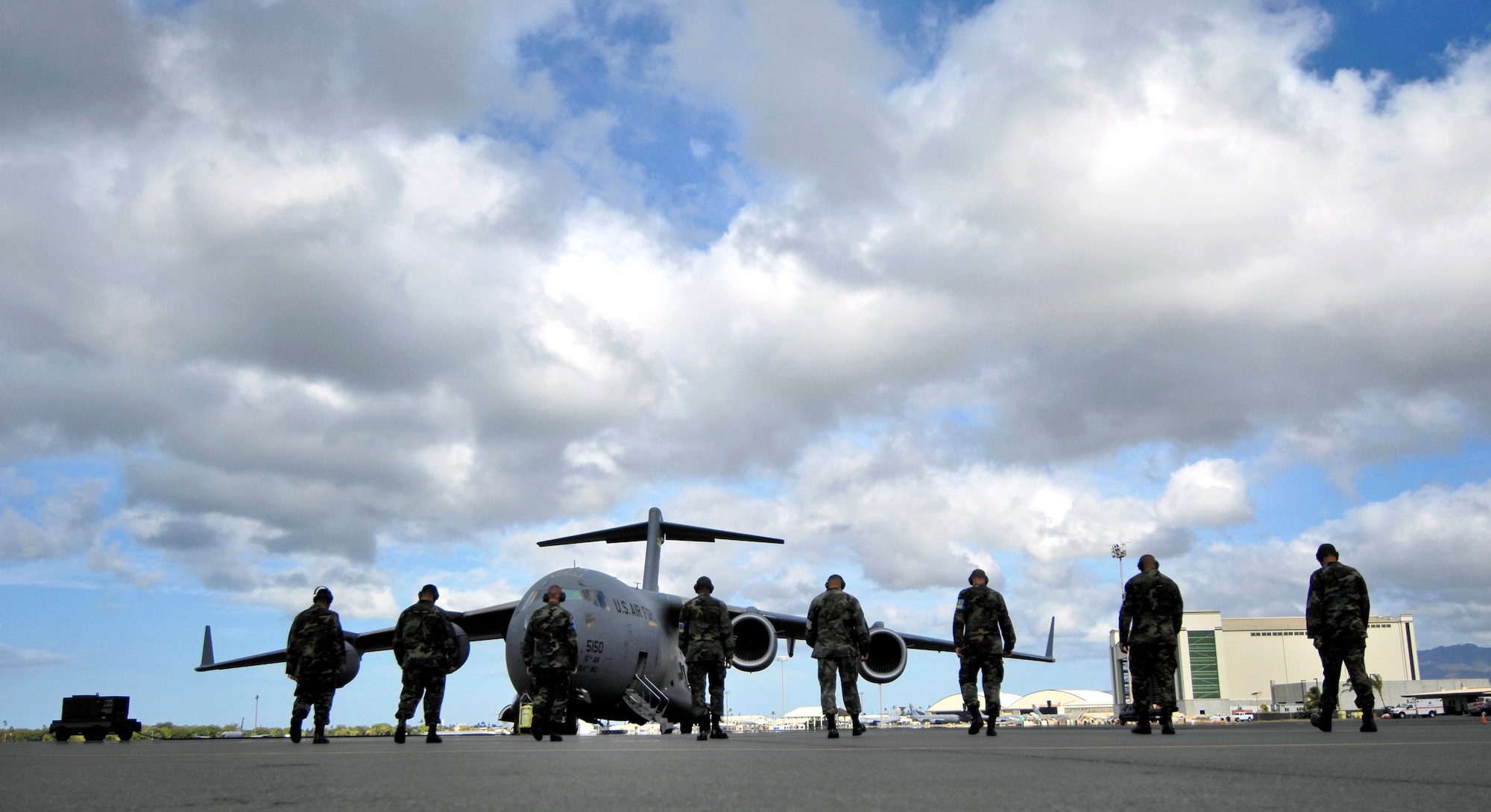 Crew chiefs conduct a foreign object debris, or FOD, walk June 28 before launching a C-17 Globemaster III from Hickam Air Force Base, Hawaii. The Airmen, from the 15th Aircraft Maintenance Squadron, are practicing for the upcoming Air Mobility Command Rodeo at McChord AFB, Wash. (U.S. Air Force photo/Tech. Sgt. Shane A. Cuomo)
