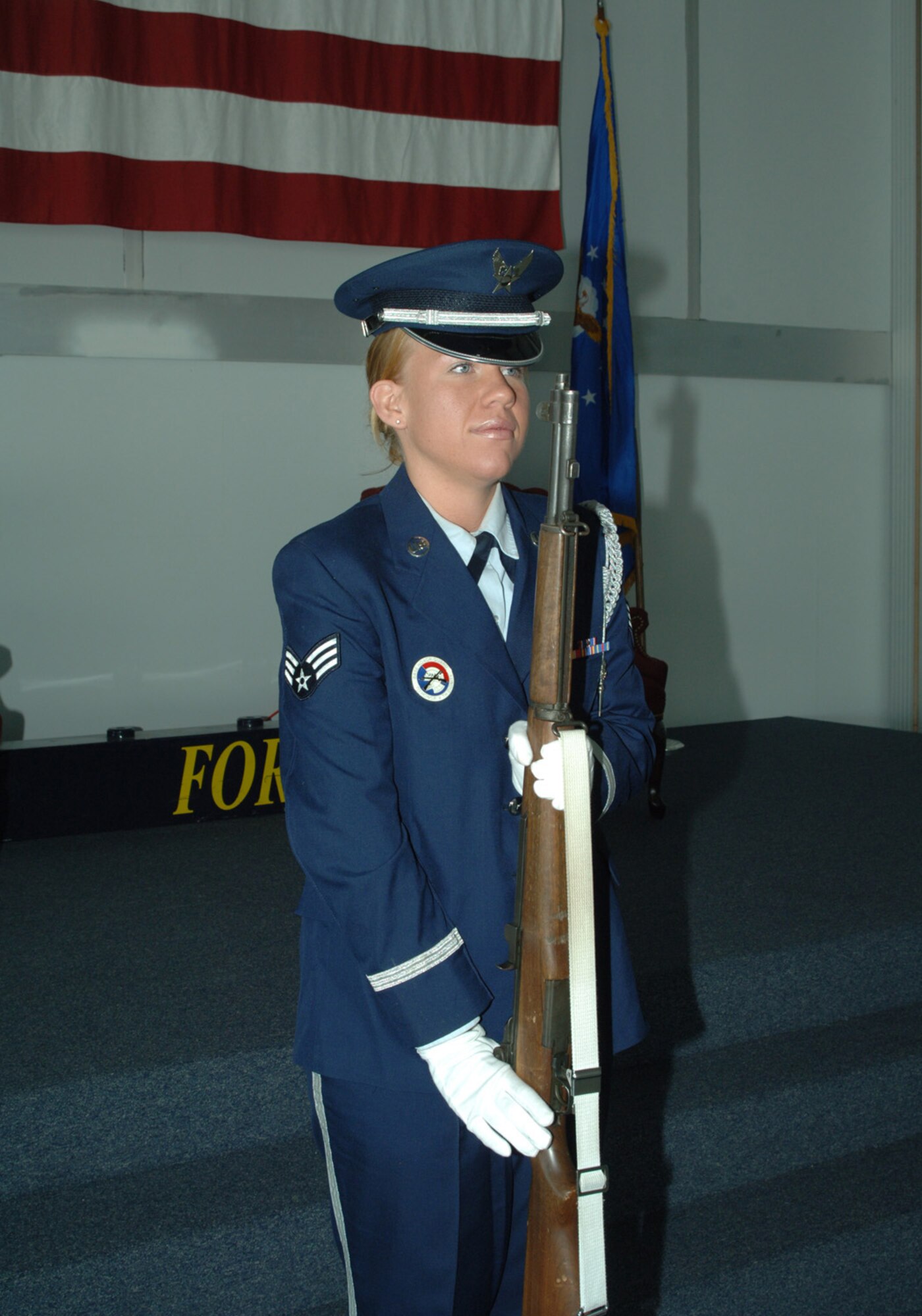 GRAND FORKS AIR FORCE BASE, N.D. -- Senior Airman Jamie Tranby presents arms during the national anthem in a recent ceremony at Grand Forks Air Force Base, N.D. Airman Tranby was recently named Air Force honor guard member of the year for 2006, an award only given to one member of the Air Force each year. (U.S. Air Force photo/Senior Airman SerMae Lampkin)