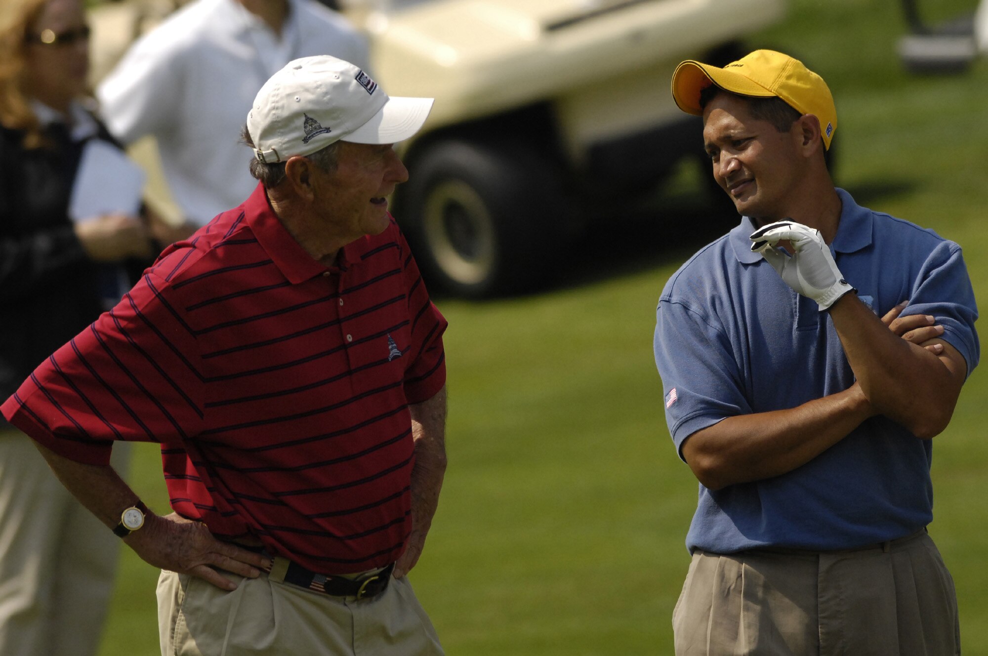 Tech. Sgt. Andy Amor, 316th Civil Engineer Squadron, Andrews Air Force Base, Md., walks down a fairway with former President George H.W. Bush at Congressional Country Club in Bethesda, Md., July 4. Sergeant Amor was selected to represent the Air Force and play with Tiger Woods at a pro-am event before the start of the AT&T National Golf Tournament at Congressional. Tiger Woods was the event host as well as a contestant and spokesman. (U.S. Air Force photo by Senior Airman Dan DeCook)
