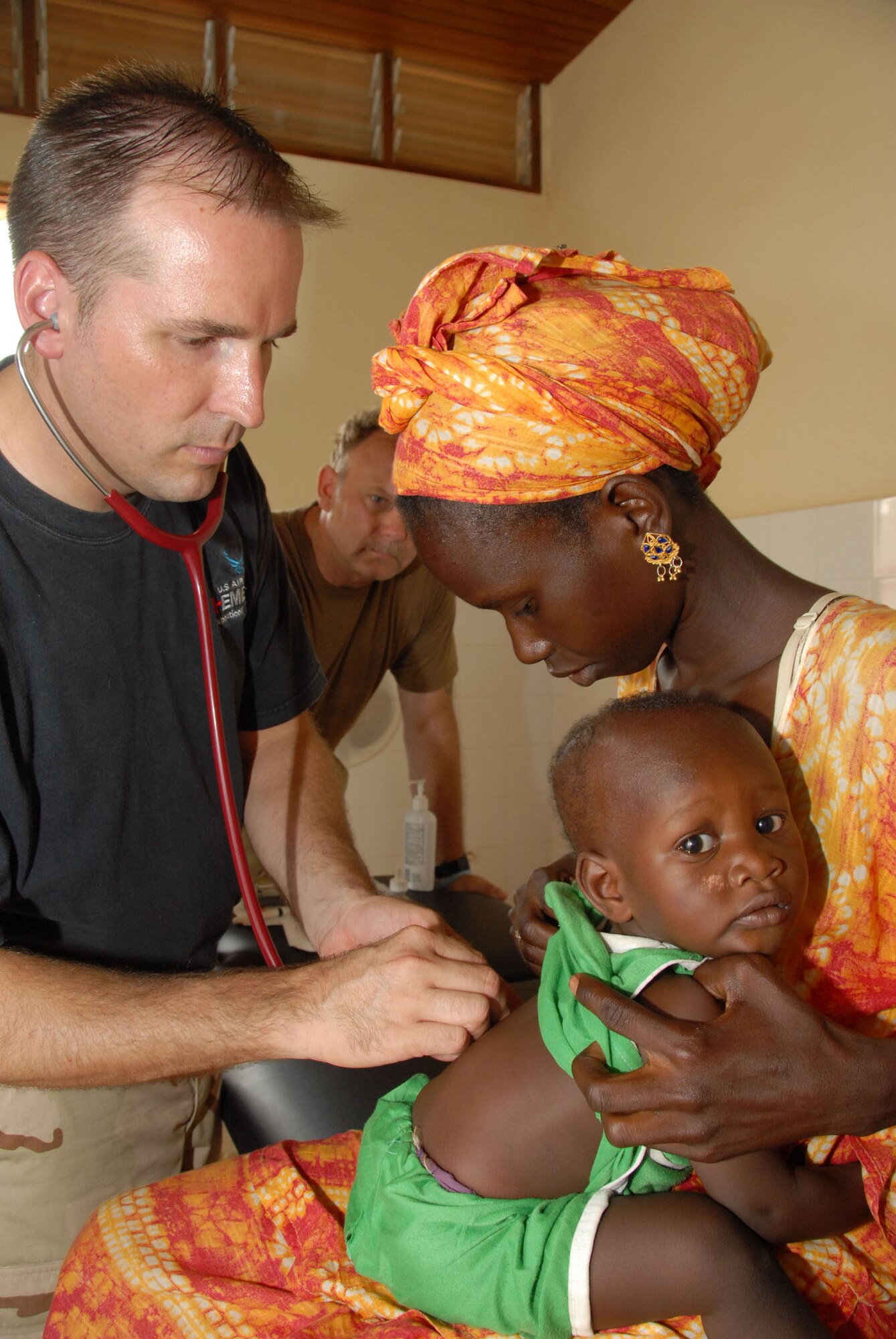 Maj. (Dr.) Darin Brimhall, a 752nd Medical Squdron phycision does a well baby exam during Shared Accord 07, as Master Sgt. Rick Brewer, a medical technician, 445 Aeromedical Staging Squdron assists in the background. (U.S. Air Force photo/Master Sgt. Chance C. Babin)