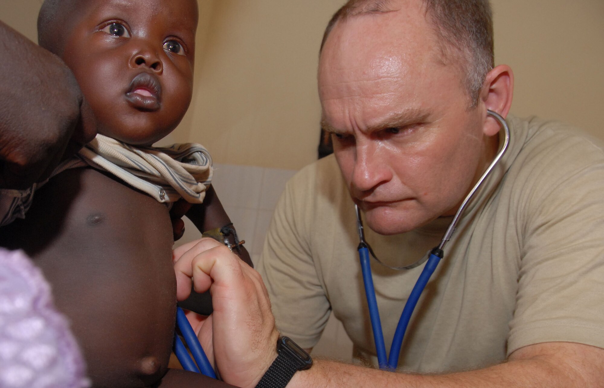 Maj. (Dr.) Brandon Isaacs, an individual mobilization augmentee flight surgeon assigned to Ellsworth Air Force Base, S.D., checks a Senegalese Baby's lungs during a routine check up. (U.S. Air Force photo/Master Sgt. Chance C. Babin)
