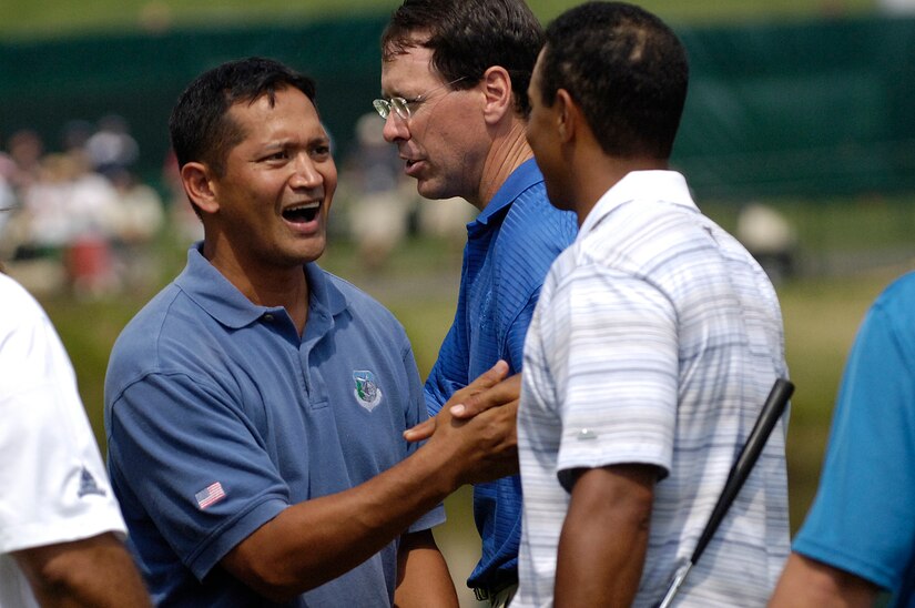 Tech. Sgt Andy Amor, 316th Civil Engineer Squadron, shakes hands with Tiger Woods after completing their round during a Pro-Am at Congressional Country Club. Sergeant Amor was selected to represent the Air Force at a Pro-Am event before the start of the AT&T National Golf Tournament at Congressional Country Club in Bethesda, Md., July 4. Tiger Woods is the event host as well as a contestant and spokes person. (U.S. Air Force photo by Senior Airman Dan DeCook)