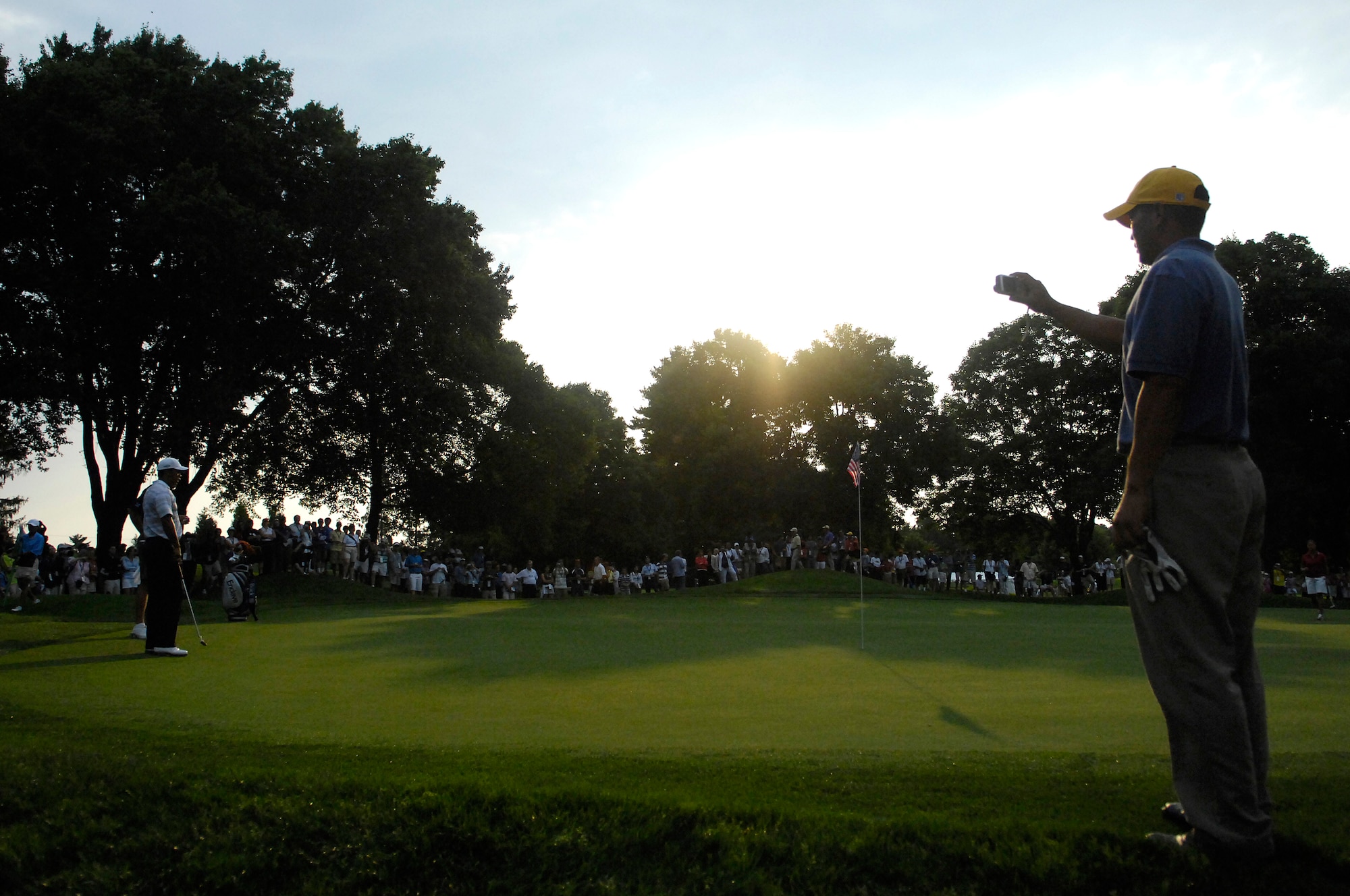Tech. Sgt Andy Amor, 316th Civil Engineer Squadron, takes a picture of Tiger Woods as he waits to putt during a Pro-Am events.  Sergeant Amor was selected to represent the Air Force and play with Tiger Woods in the Pro-Am event before the start of the AT&T National Golf Tournament at Congressional Country Club in Bethesda, Md., July 4. Tiger Woods is the event host as well as a contestant and spokes person. (U.S. Air Force photo by Senior Airman Dan DeCook)
