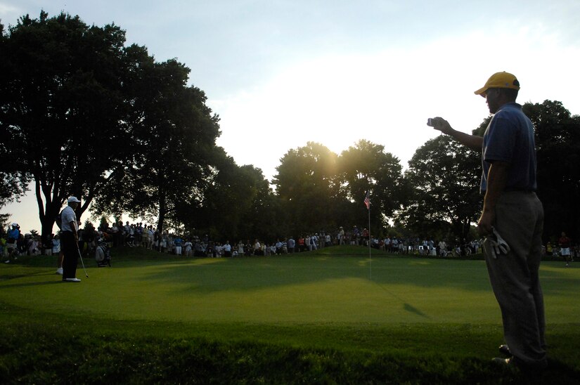 Tech. Sgt Andy Amor, 316th Civil Engineer Squadron, takes a picture of Tiger Woods as he waits to putt during a Pro-Am events.  Sergeant Amor was selected to represent the Air Force and play with Tiger Woods in the Pro-Am event before the start of the AT&T National Golf Tournament at Congressional Country Club in Bethesda, Md., July 4. Tiger Woods is the event host as well as a contestant and spokes person. (U.S. Air Force photo by Senior Airman Dan DeCook)