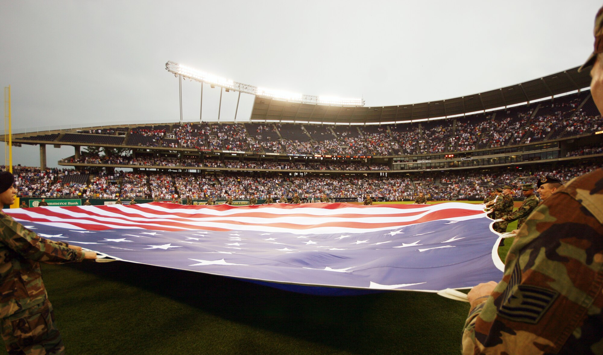 KANSAS CITY, Mo. - More than 30 Team Whiteman members display the Stars and Stripes in centerfield during the National Anthem July 4 at Kaufmann Stadium, home of the Kansas City Royals. The ball club invited the Airmen to take part in Independence Day celebrations before the game and then catch the Royals in action vs. the Seatlle Mariners. The Mariners won the game 4-0. (U.S. Air Force photo/Tech. Sgt. Matt Summers)