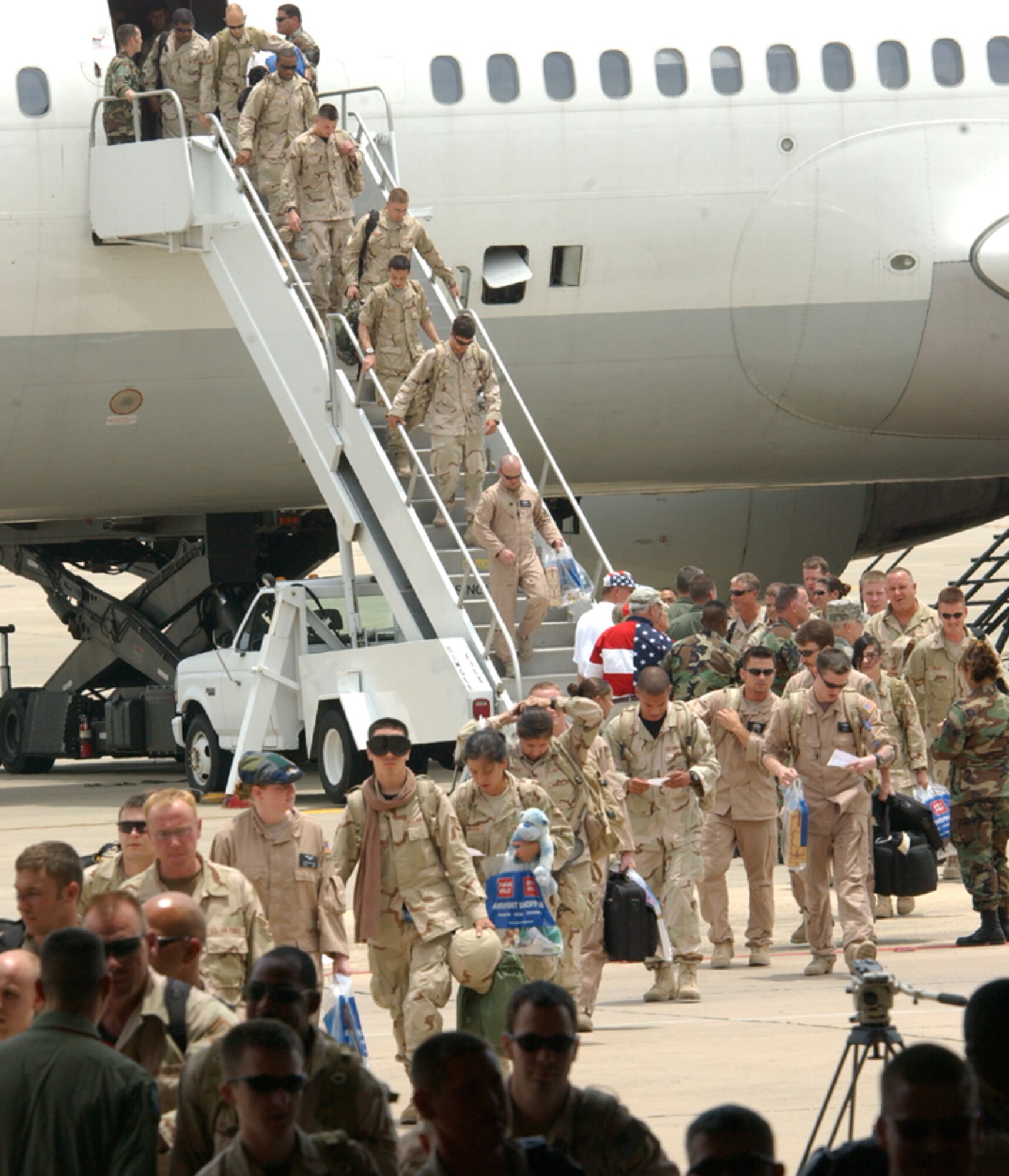 Airmen step off their plane and head for the arms of the loved ones they haven't seen in months while they were deployed to Iraq and Afghanistan. More than 200 Airmen returned to Hurlburt Field July 4.  (U.S. Air Force photo by Tech. Sgt. Angela Shepherd)