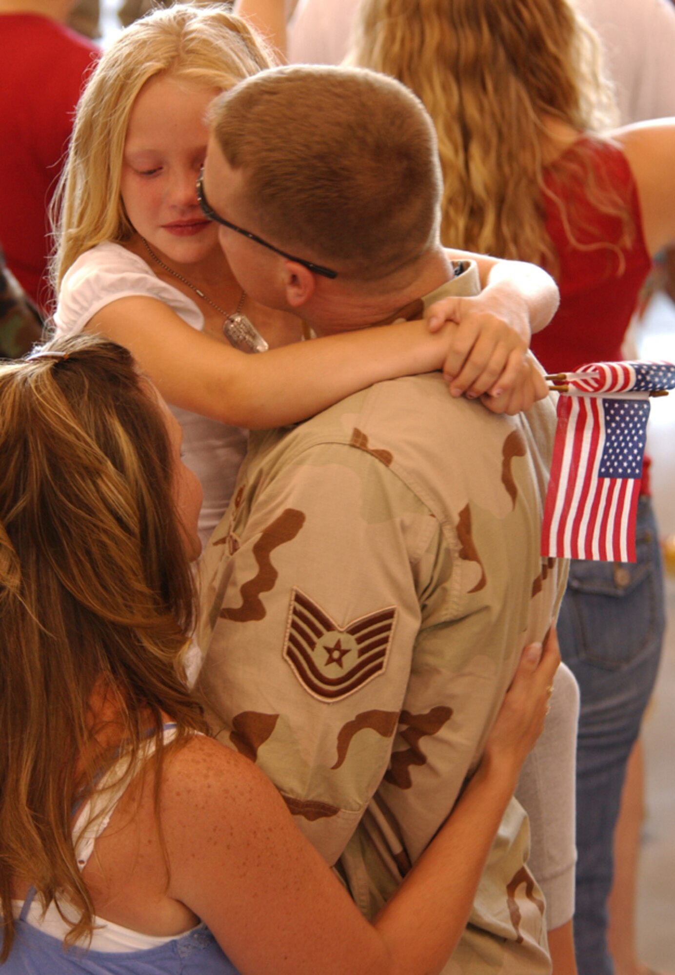 Tech. Sgt. Alan Finck, 1st Special Operations Equipment Maintenance Squadron, comforts his daughter after returning from his deployment July 4. He was one of the more than 200 Airmen who returned from deployments in support of Operations Iraqi and Enduring Freedom on Independence Day. (U.S. Air Force photo by Tech. Sgt. Angela Shepherd)