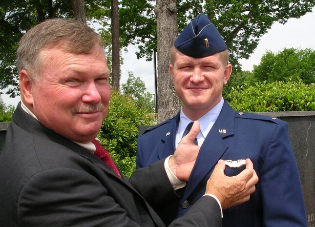 Capt. Gregg Brock, 16th Airlift Squadron C-17 pilot and standard evaluation liaison officer, has is father, Veston Brock Jr., pin his wings on his uniform for the first time when he was a second lieutenant.  (U.S. Air Force photo/ Staff Sgt. April Quintanilla) 