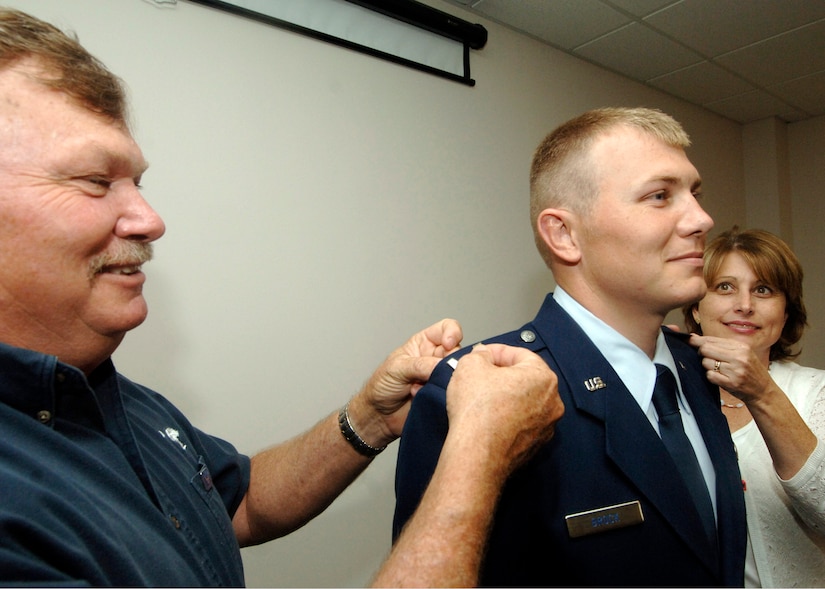 2nd Lt. Colt Brock, 437th Contracting Squadron acquisition officer, is pinned on the rank of first lieutenant by his parents, Veston and Gwyn Brock, June 5.  (U.S. Air Force photo/ Staff Sgt. April Quintanilla)