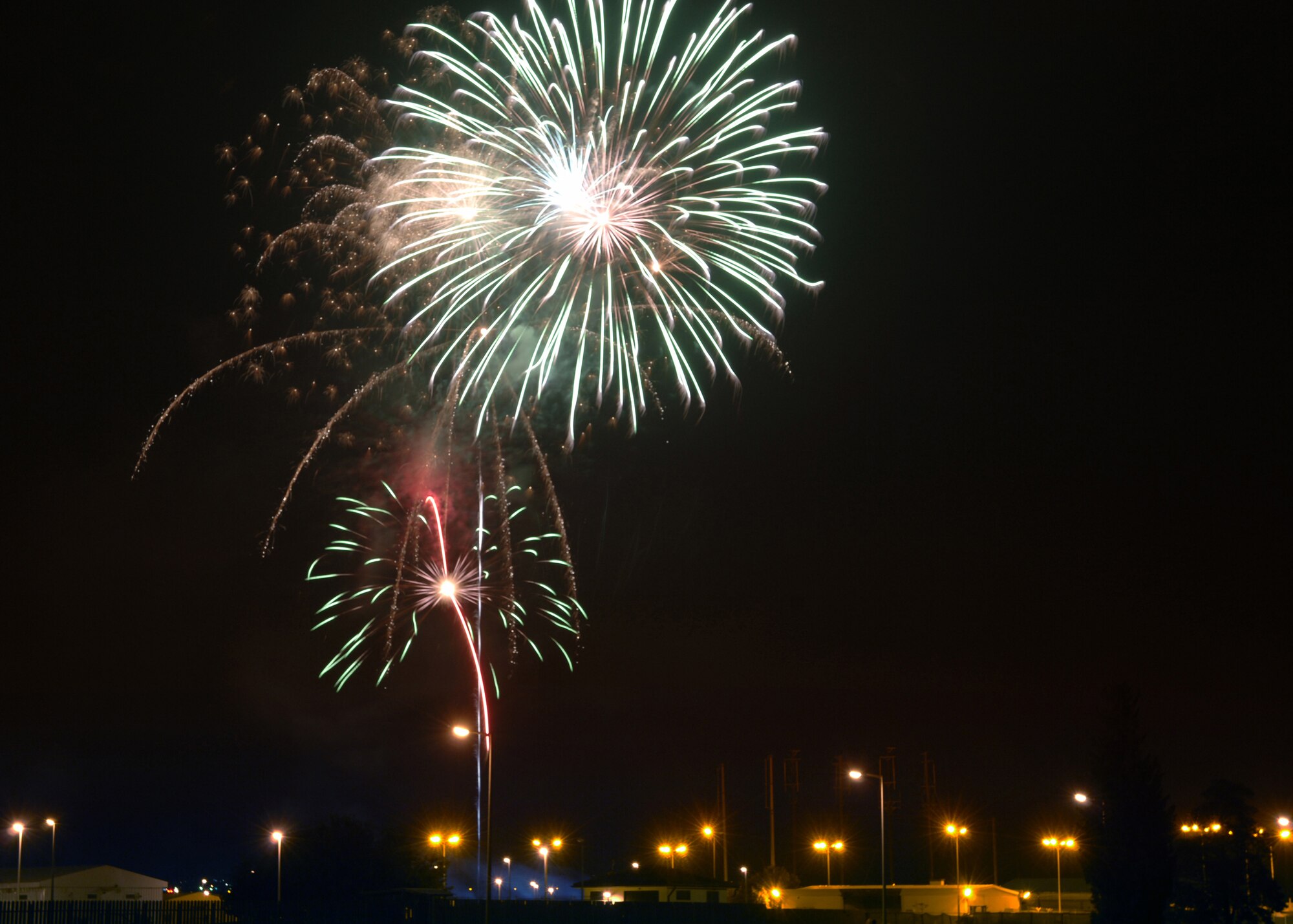 Fireworks burst over Patriot Village during the 4th of July celebration at Arkadas Park.  The festivities included fireworks, food and music by the Armed Forces Entertainment band Sole Funktion. (U. S. Air Force photo by Airman 1st Class Nathan W. Lipscomb)