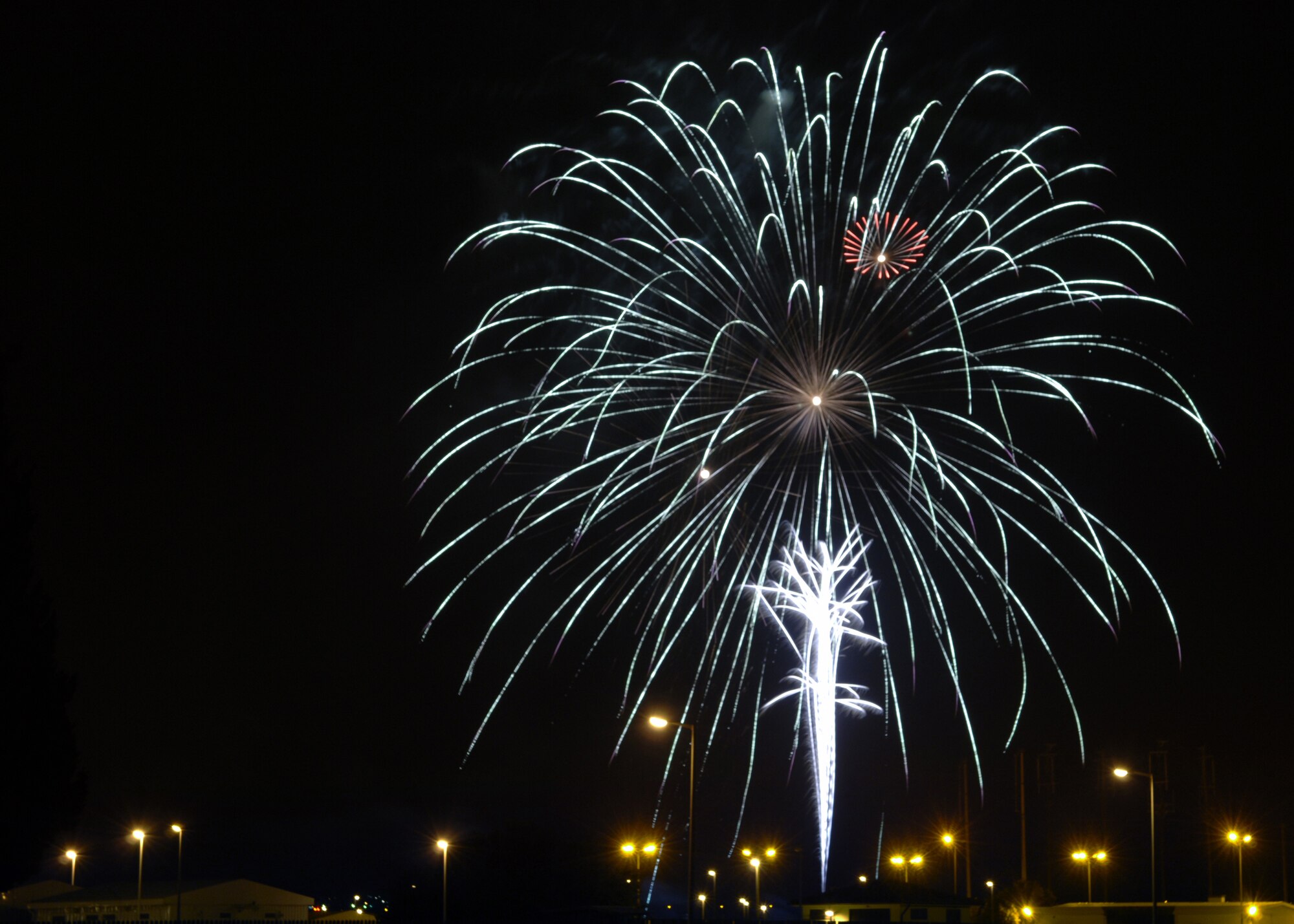 Fireworks burst over Patriot Village during the 4th of July celebration at Arkadas Park.  The festivities included fireworks, food and music by the Armed Forces Entertainment band Sole Funktion. (U. S. Air Force photo by Airman 1st Class Nathan W. Lipscomb)